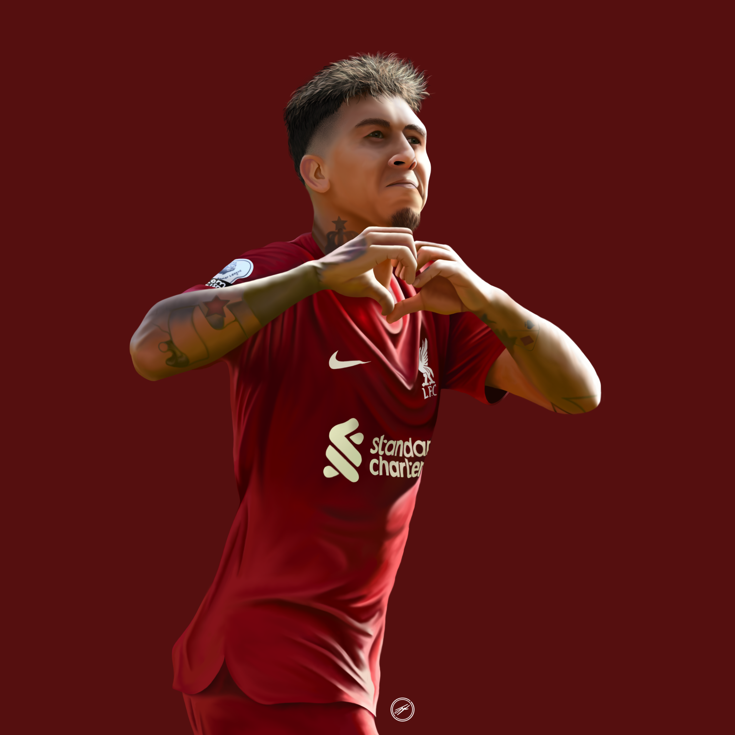 A male soccer player in a red Liverpool FC jersey making a heart shape with his hands, standing against a red background.