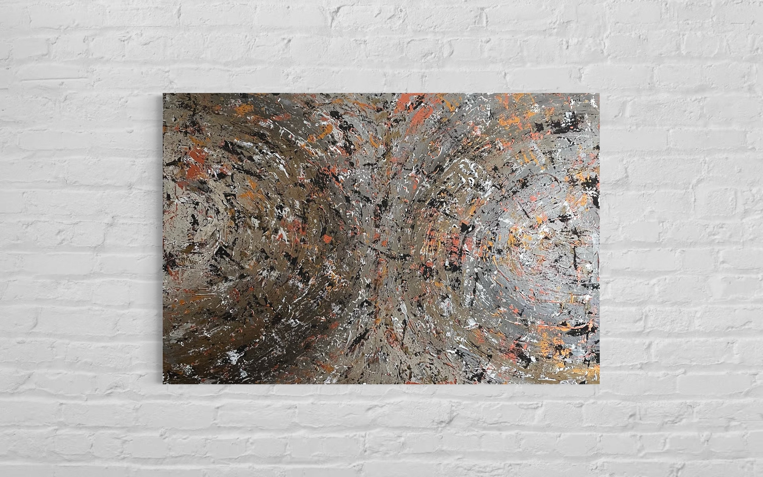 Abstract painting with swirling patterns in black, white, gray, orange, and gold tones hanging on a white brick wall.