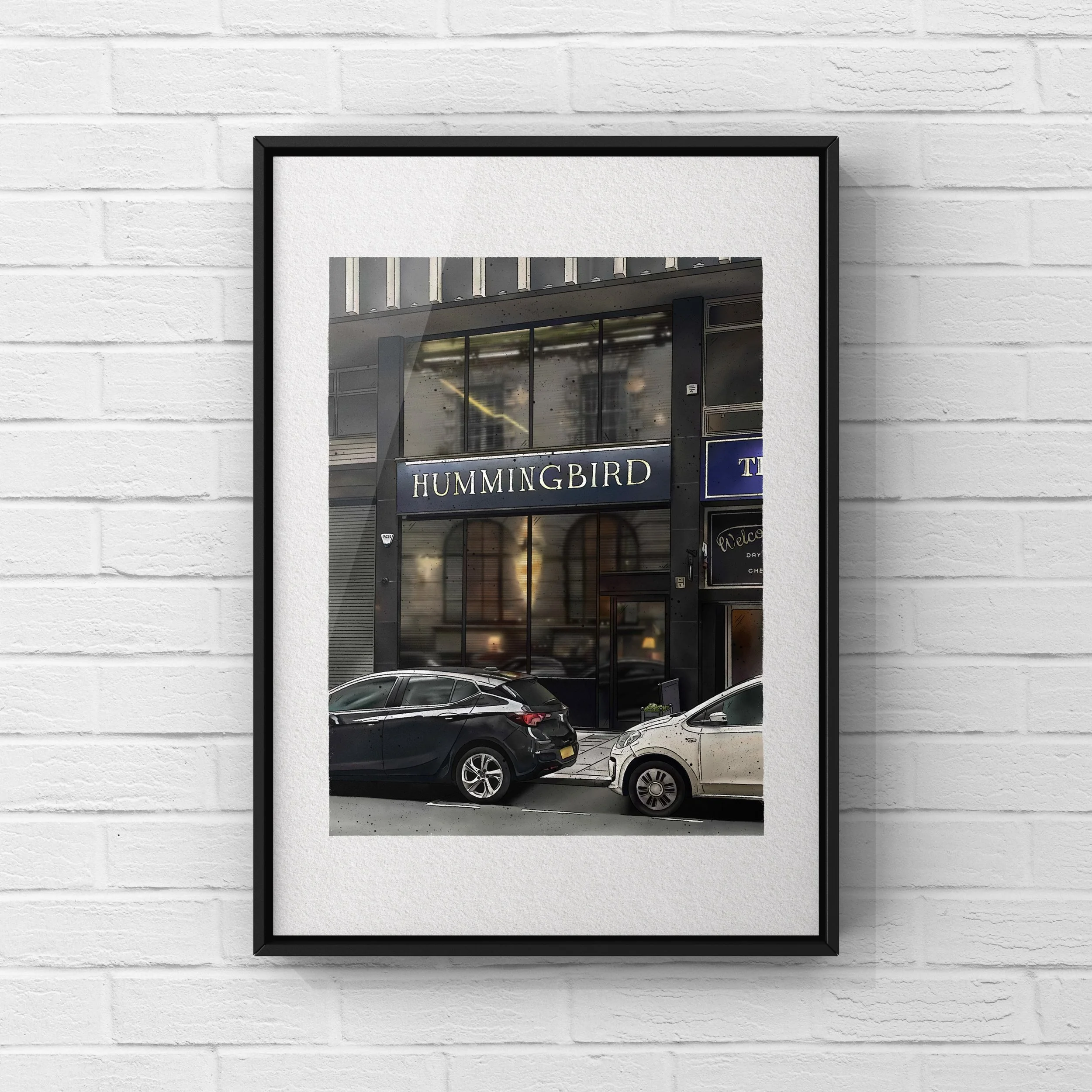 Photo of a city street showing a building with a sign that reads 'HUMMINGBIRD' above the entrance, parked cars in front, and reflections on the glass facade.