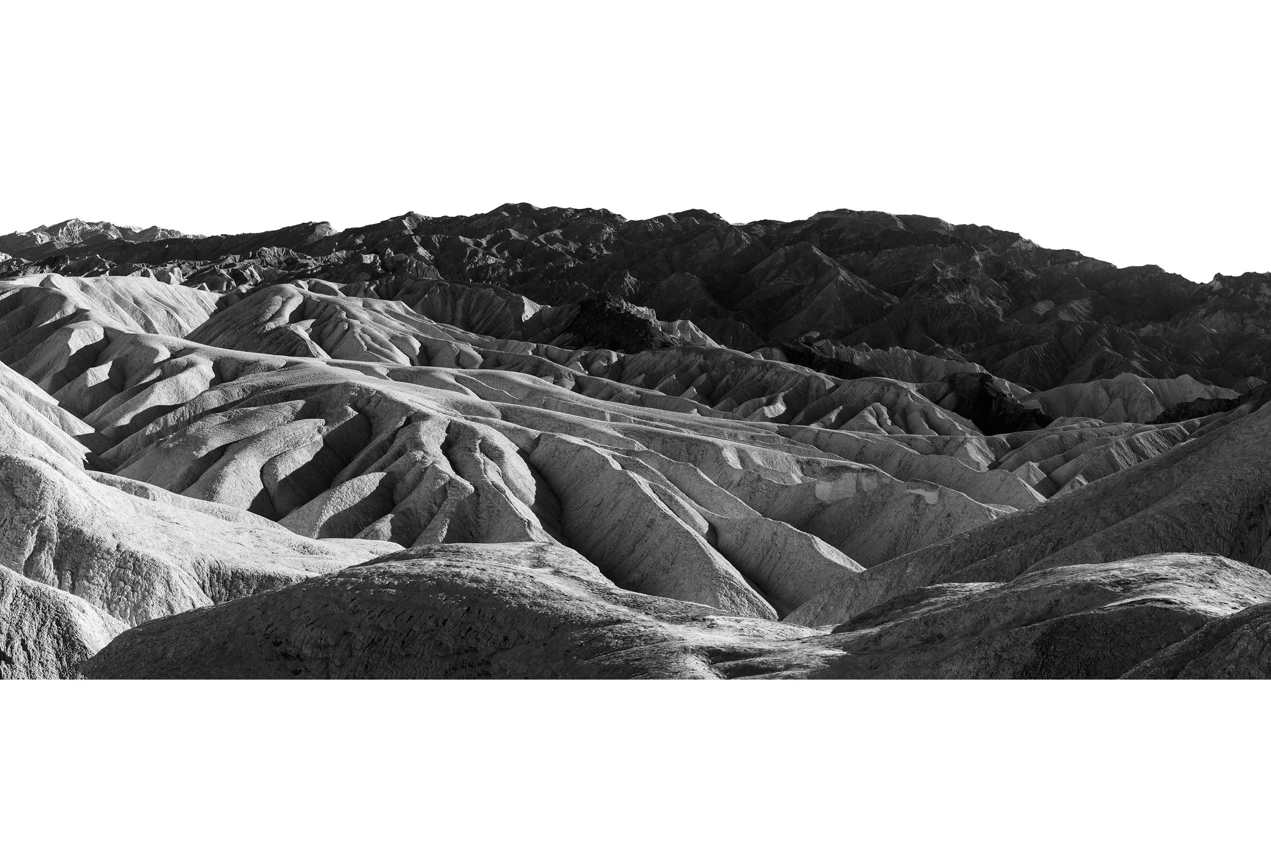 Black and white photo of rugged, eroded hills in Death Valley—a striking landscape that feels like natural art.