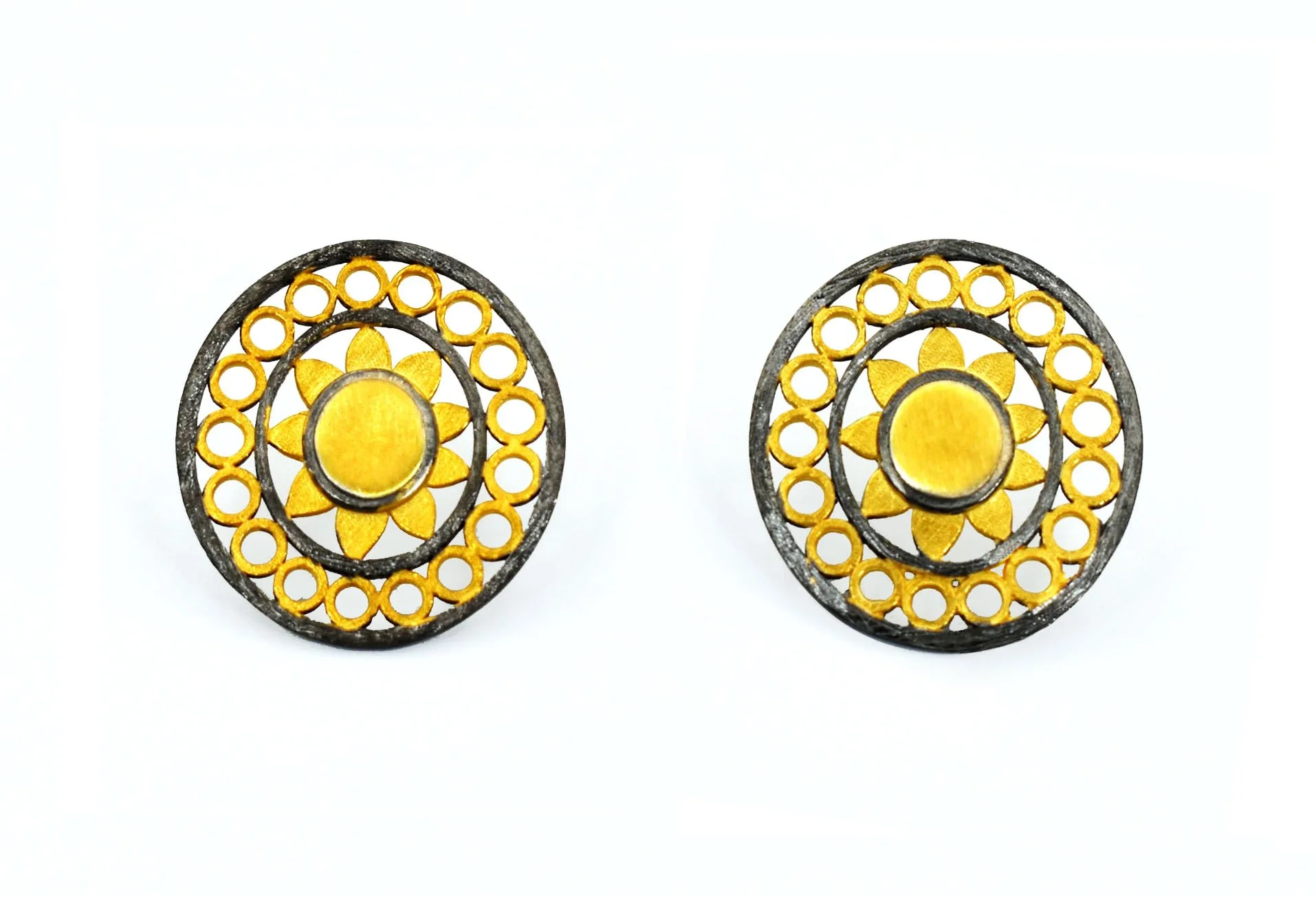 Pair of decorative earrings with yellow flower design and black circular border, aligned symmetrically on a white background.