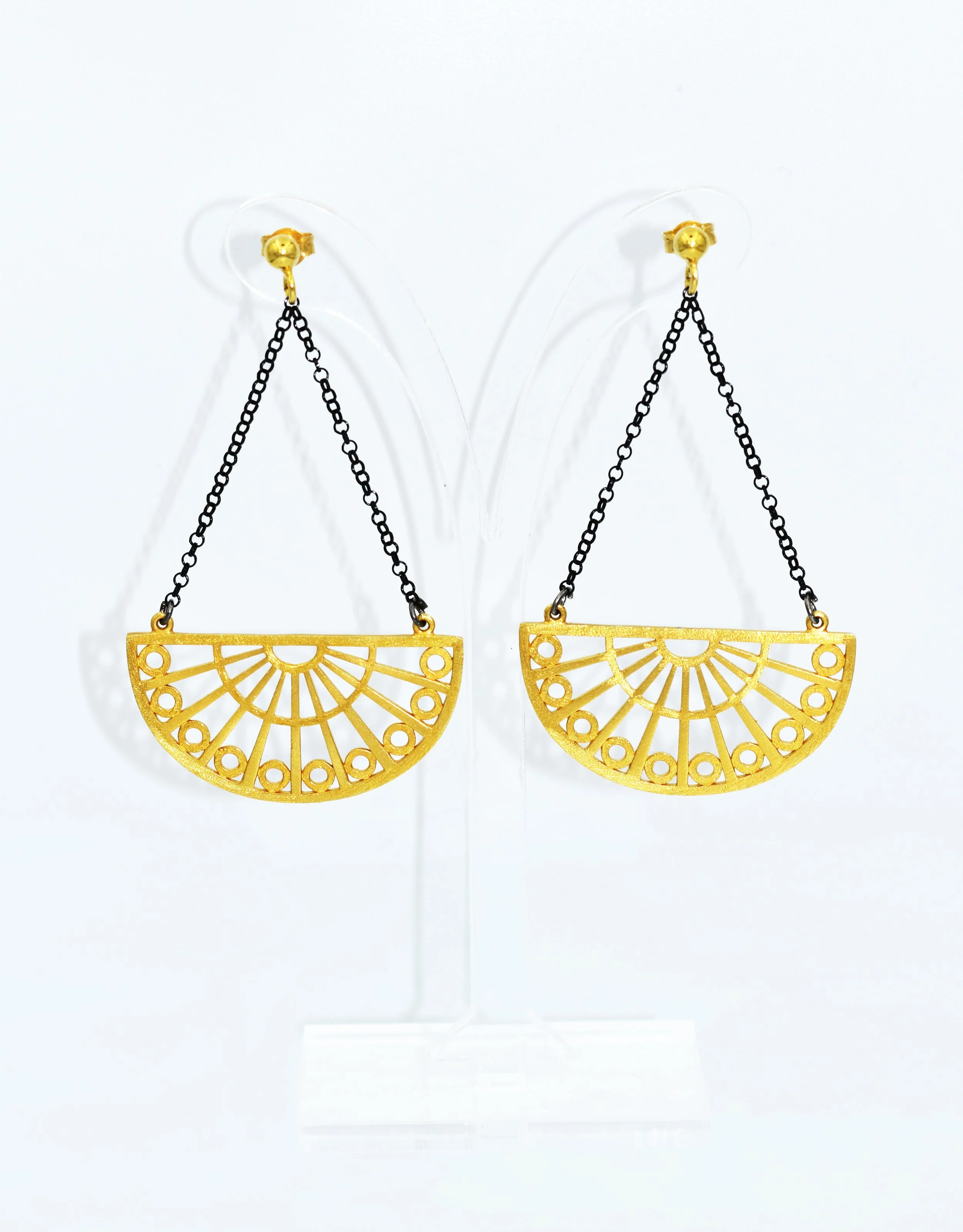 Pair of gold earrings with black chains and fan-shaped designs on a white background.