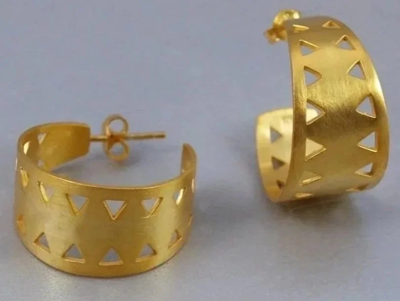 Gold hoop earrings with triangular cutouts.
