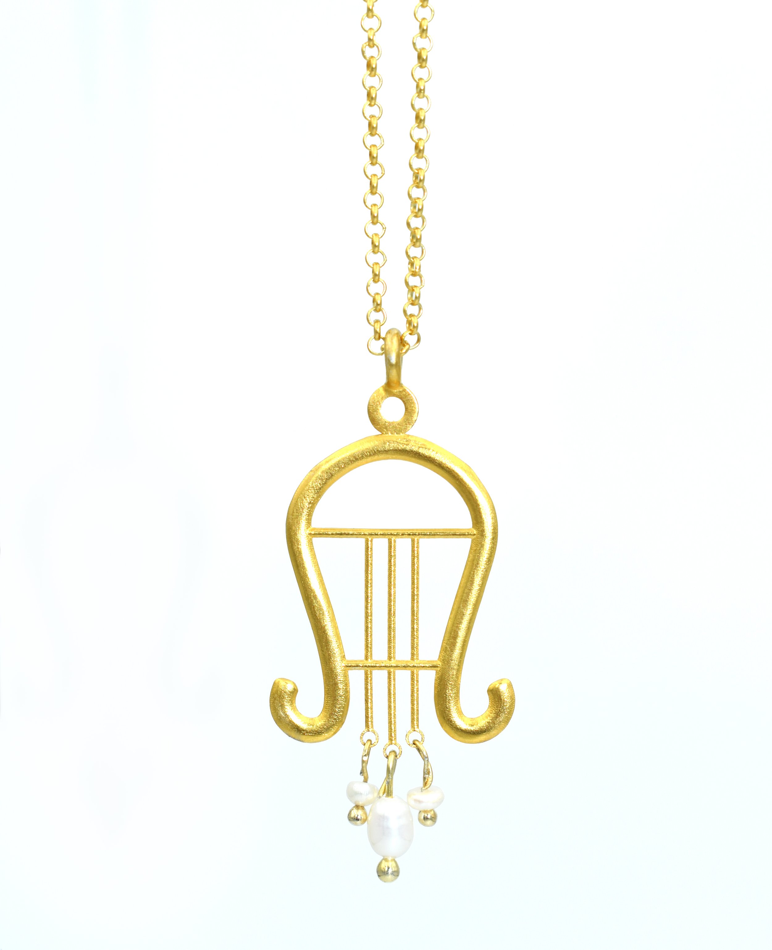 Gold necklace with a pendant shaped like a lyre and small pearl accents hanging from the bottom.