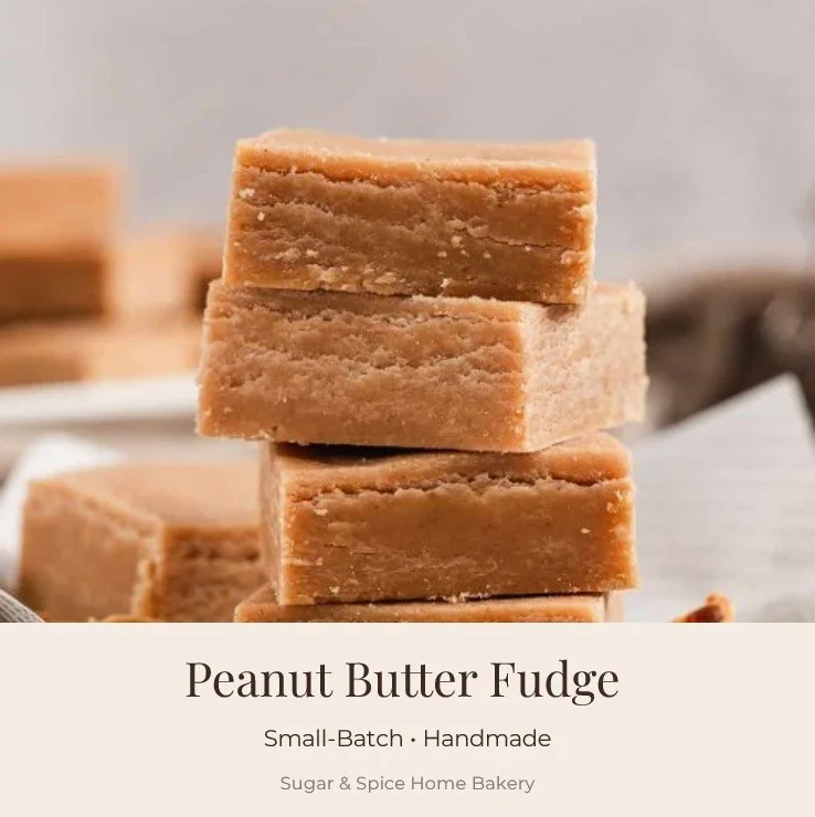 Stacked pieces of peanut butter fudge on a white surface with blurred background.