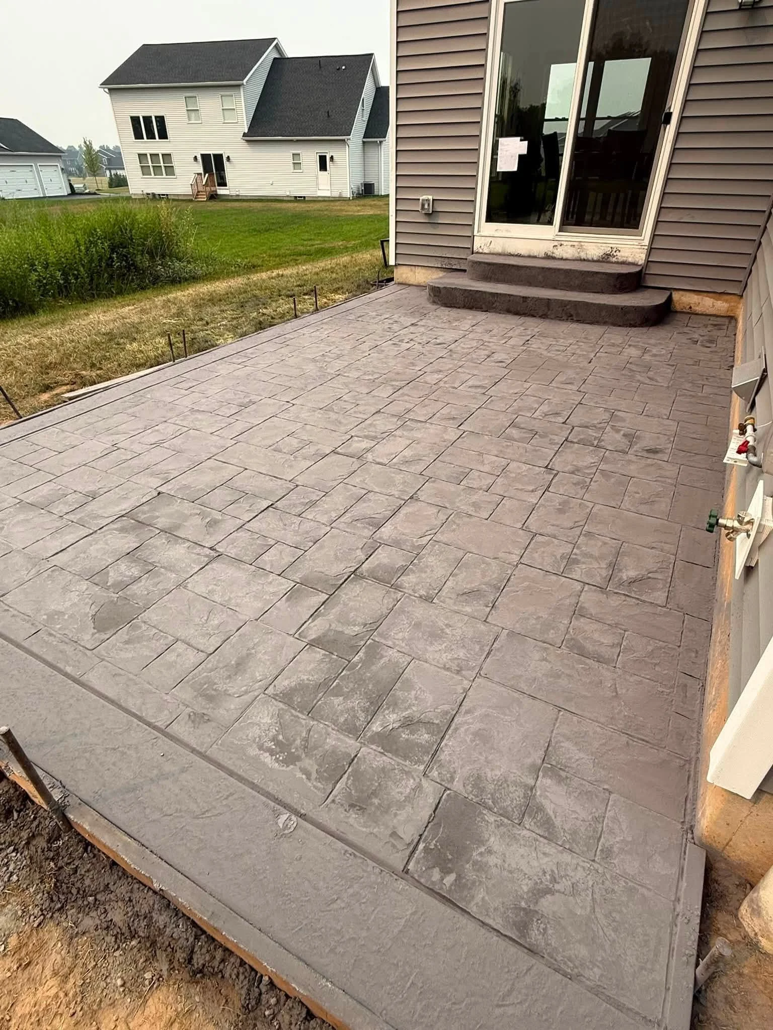 Elevating WNY Outdoor Living: Stamped Concrete Trends &amp; Essential Maintenance for Western New York Homeowners