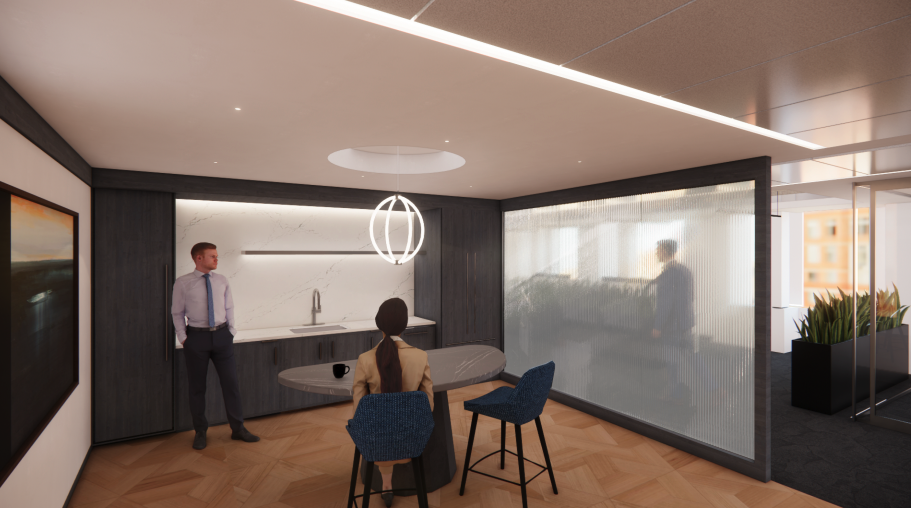 A modern office or conference room with a kitchenette, a round table, two chairs, and two people, one standing and one sitting, engaged in conversation. The room features sleek design elements, with a dark accent wall, a large artwork, hanging light 