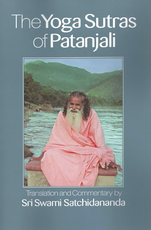 Book cover titled 'The Yoga Sutras of Patanjali' with translation and commentary by Sri Swami Satchidananda. The cover features an image of a smiling man wearing a pink robe, sitting outdoors near a body of water with lush green hills in the backgrou