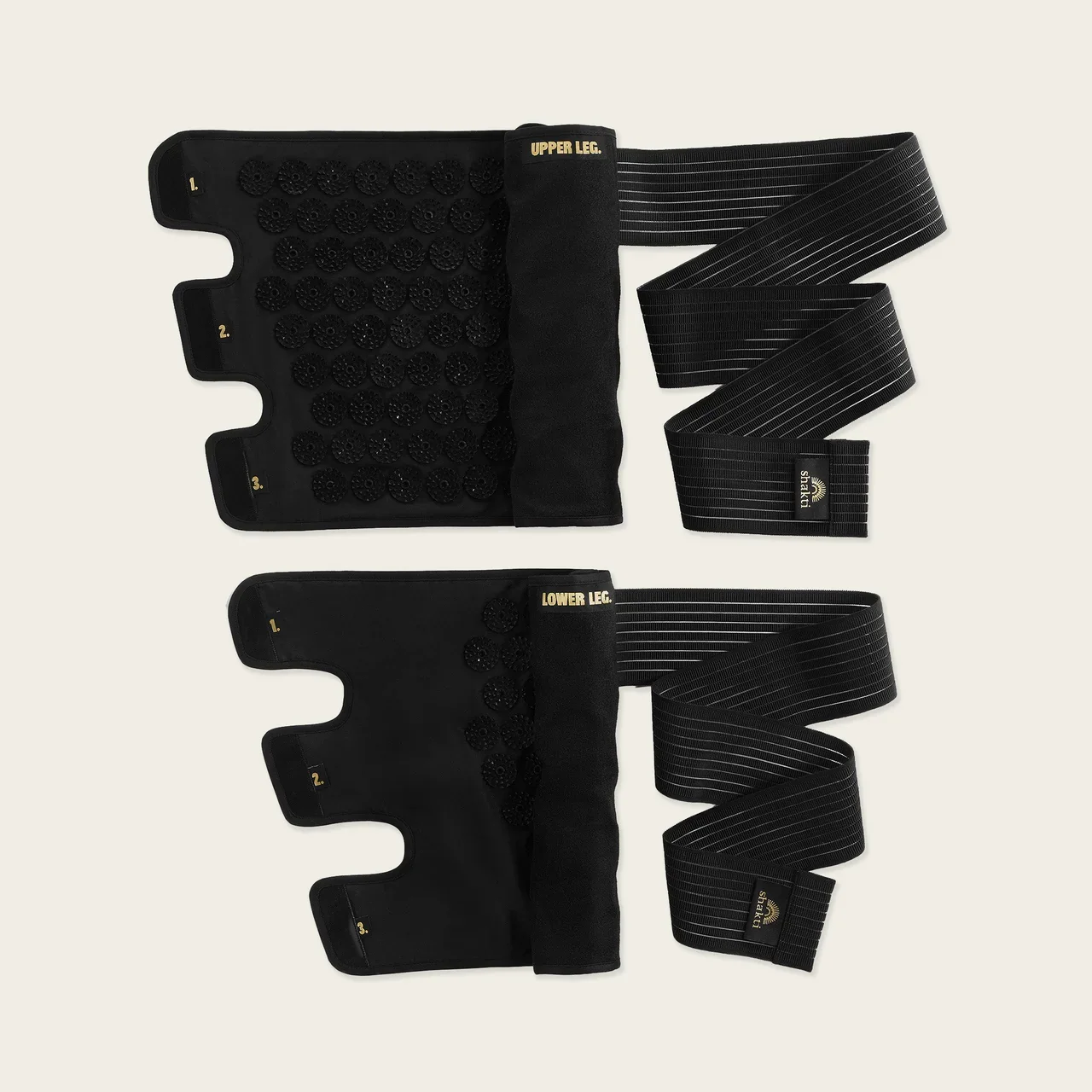 Black therapy or massage compression wraps with adjustable straps and textured pads.