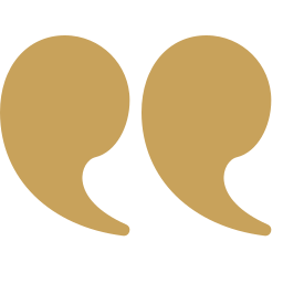 Two large gold quotation marks on a black background.