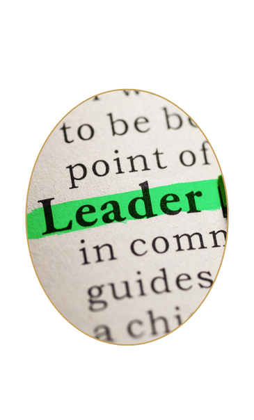 Close-up of a book page showing the word 'Leader' highlighted in green.