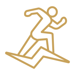 Gold-colored icon of a person surfing on a wave.