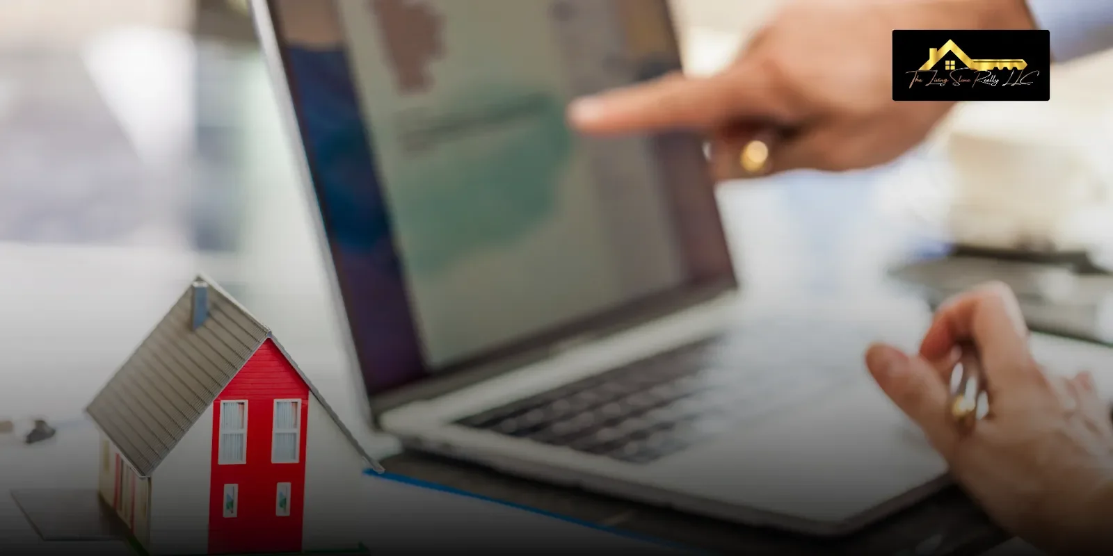 A homeowner pointing at property information on a laptop beside a small house model, showing what is the fastest way to sell your house in Reno when urgent situations require quick online research and fast solutions.