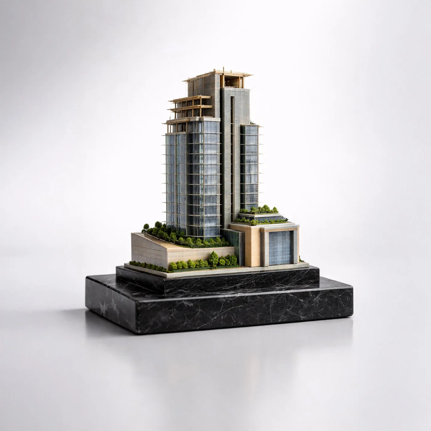 Finished architectural deal toy on a black marble base, studio lit, showing the completed commemorative object after hand finishing.