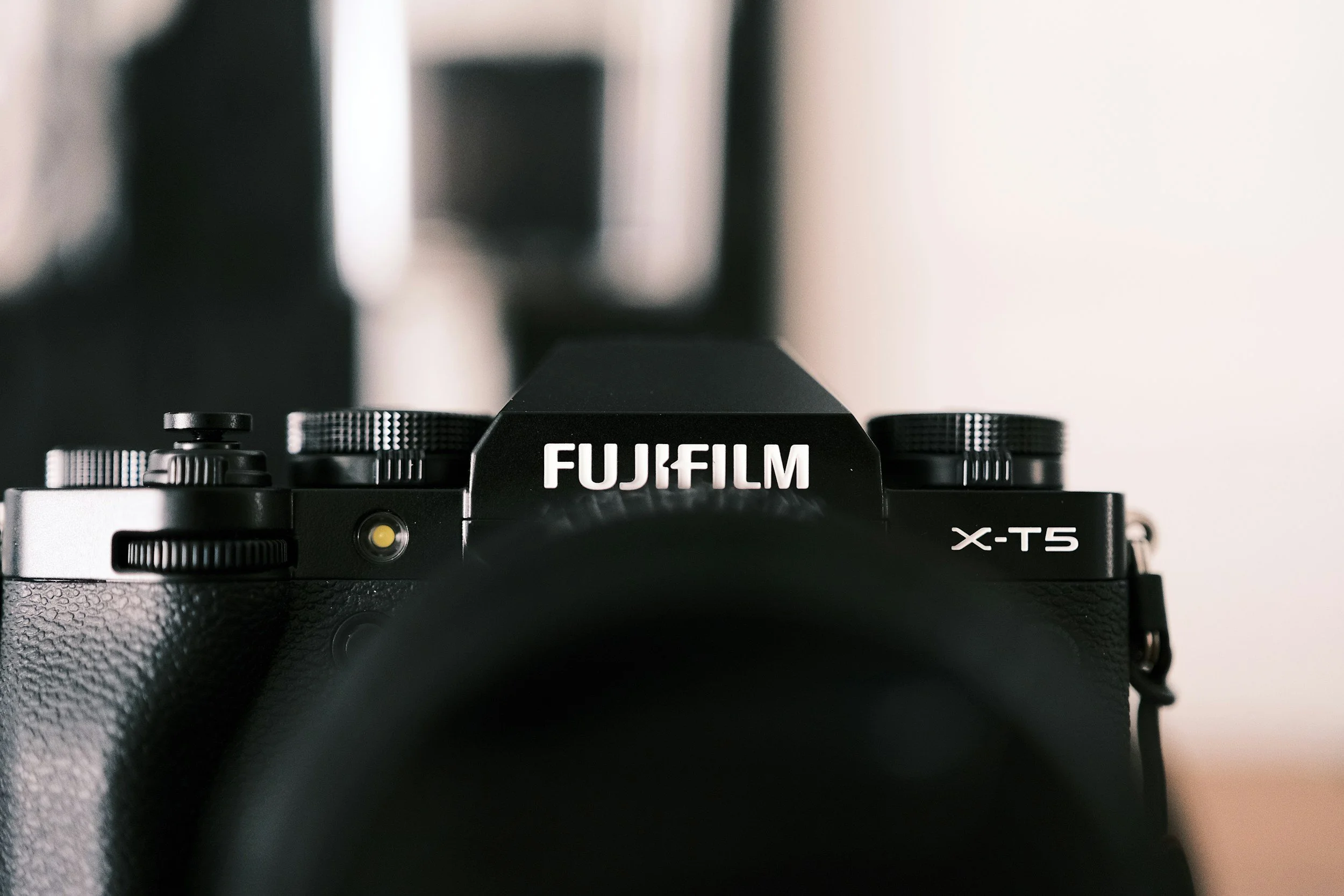 Close-up of a black Fujifilm X-T5 camera viewed from the front.