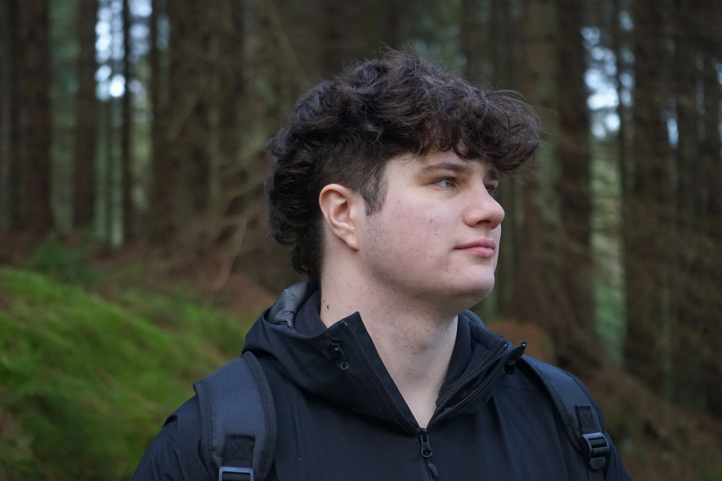 picture of Adam in a black jacket looking to the side