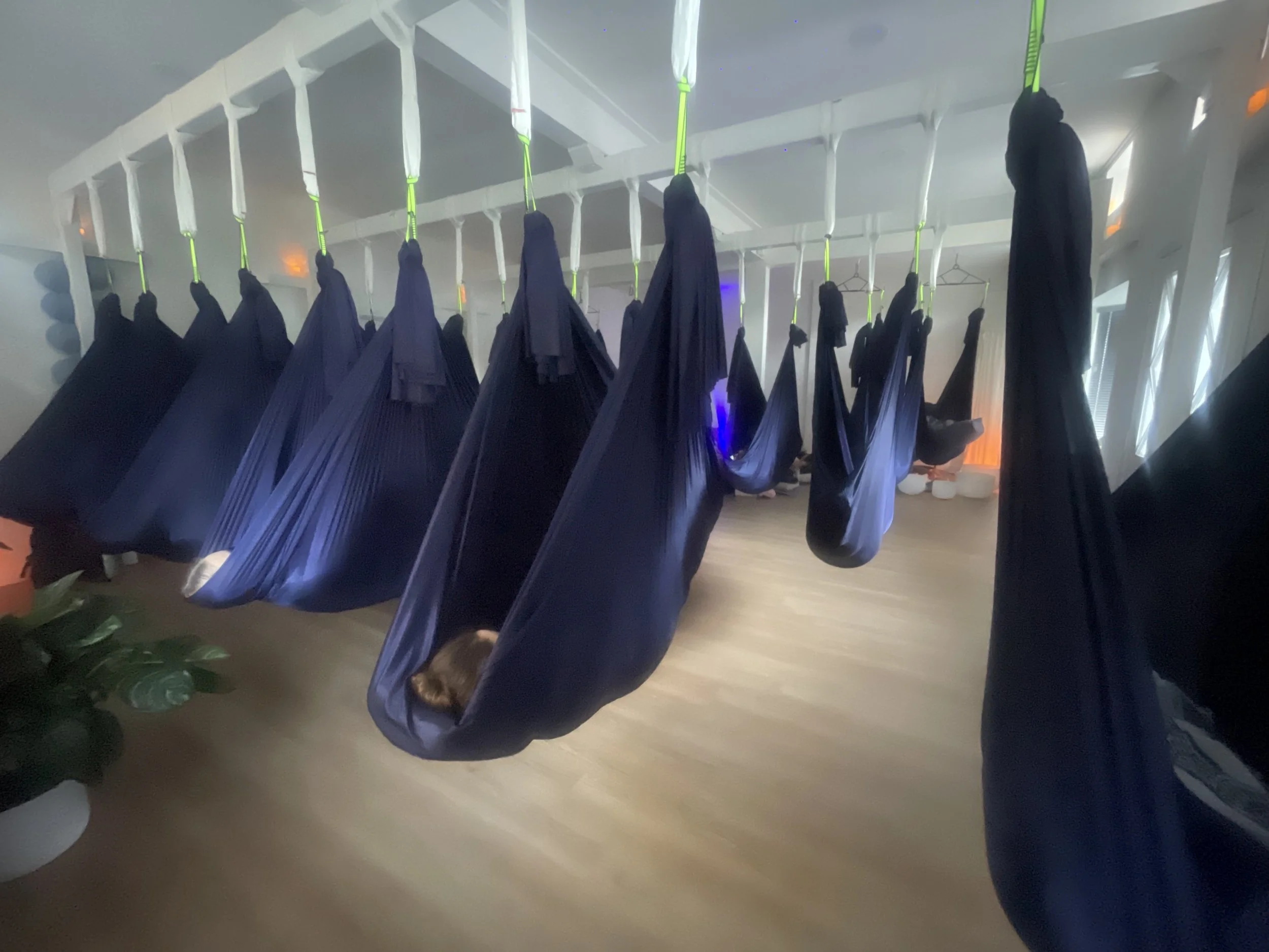 Indoor spa setting with hanging fabric drapes and lit candles