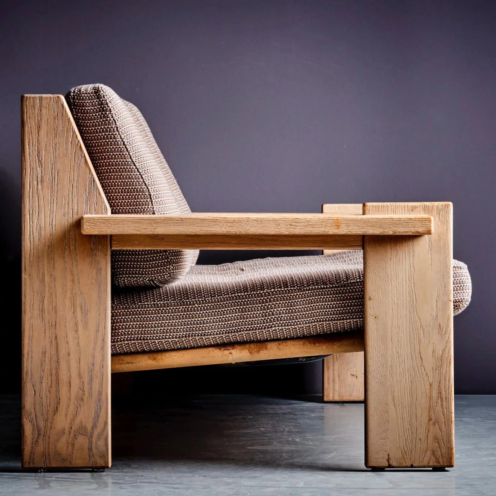 Side view of a vintage brutalist lounge chair, reimagined by New York/London-based designer Charlie FERRER for The Select Project Series. Wood Frame, Upholstered in artisanal fabric by Boon & Up, woven in Ghana using locally sourced cotton