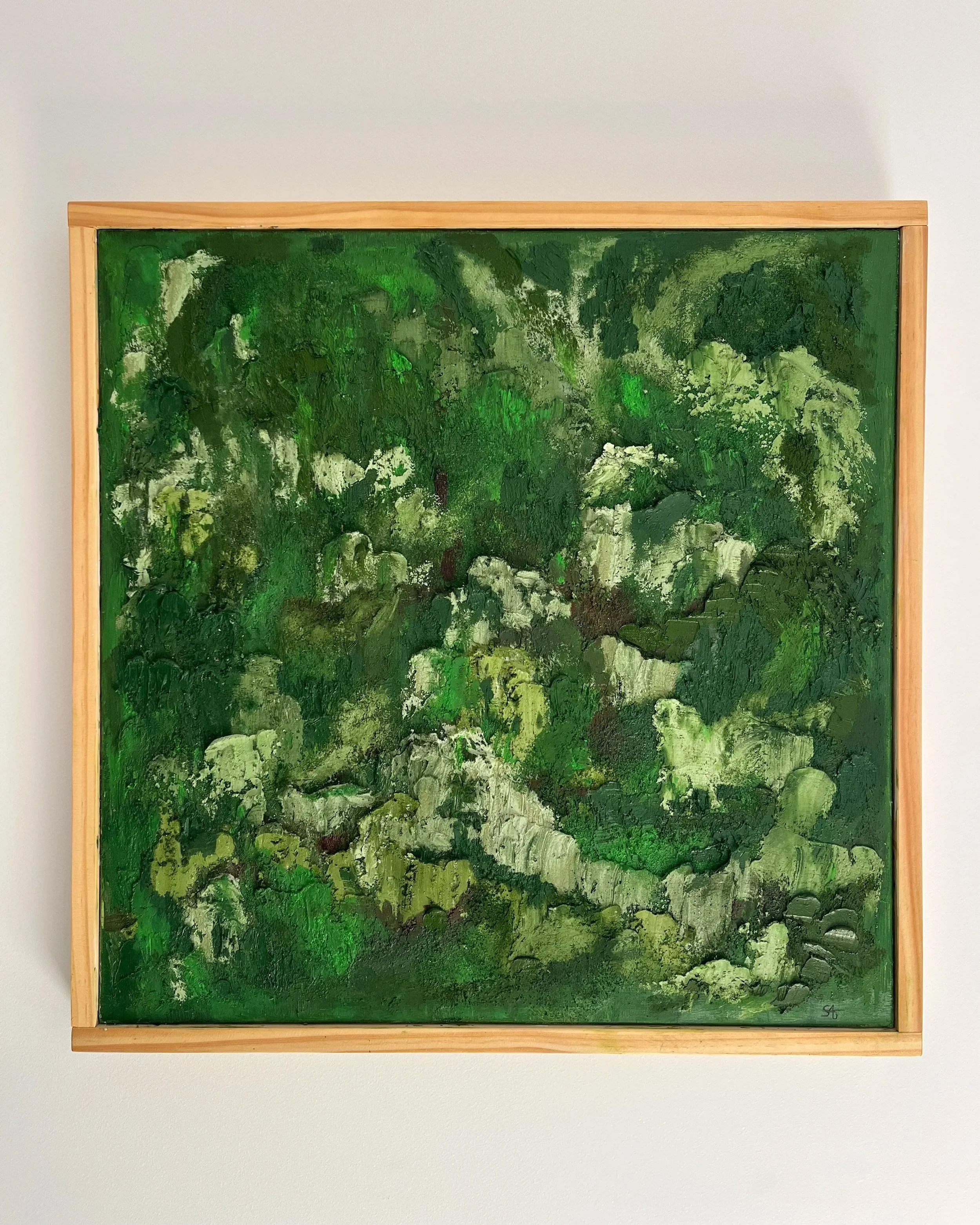 Abstract painting with various shades of green and some dark and light patches, framed in light wood.