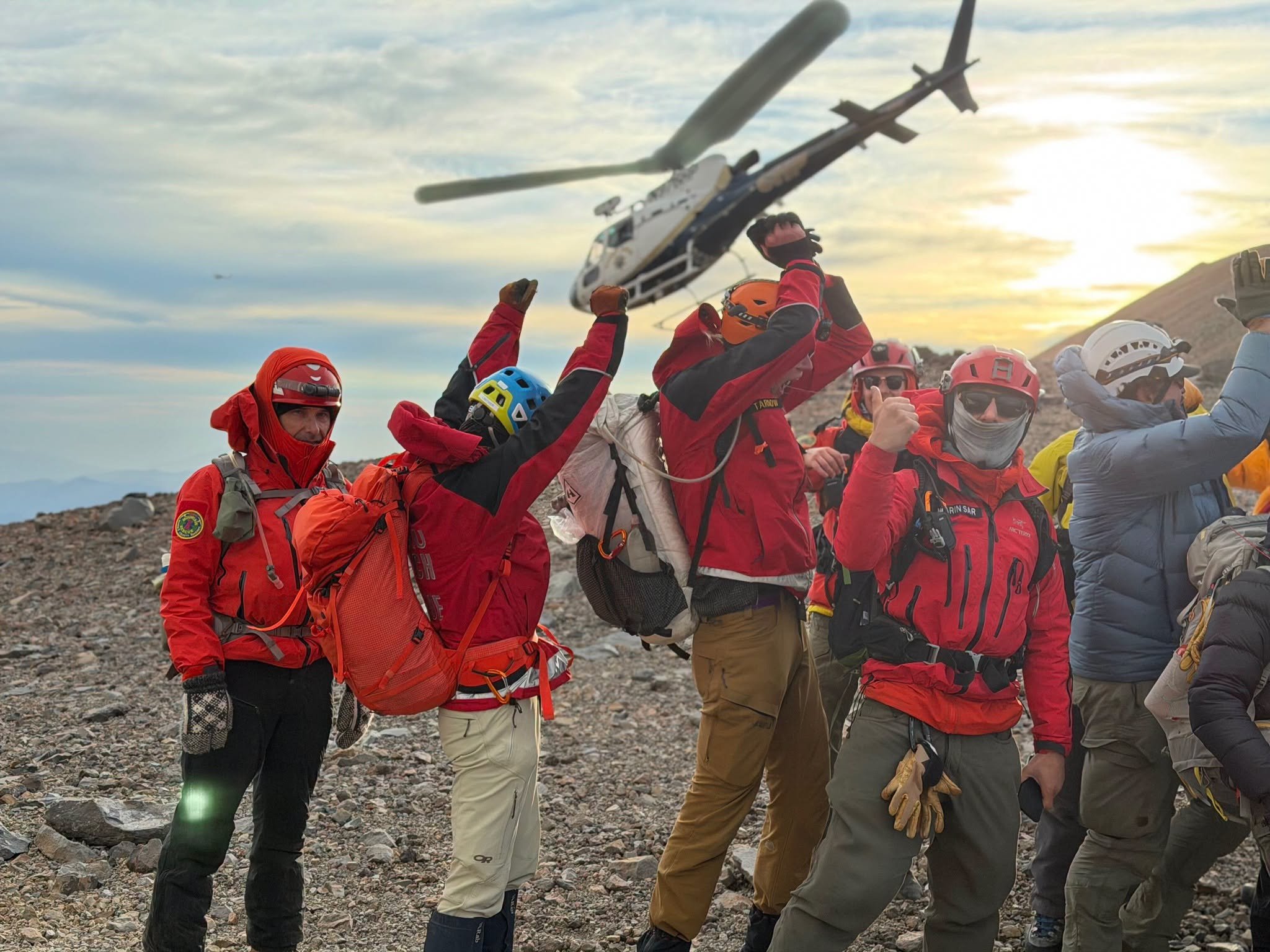   Rescue Mission Completed:  Search and rescue personnel celebrate the successful helicopter extraction of an injured climber from Mount Shasta on Tuesday, October 20. The three-day operation brought together rescue teams from multiple California cou
