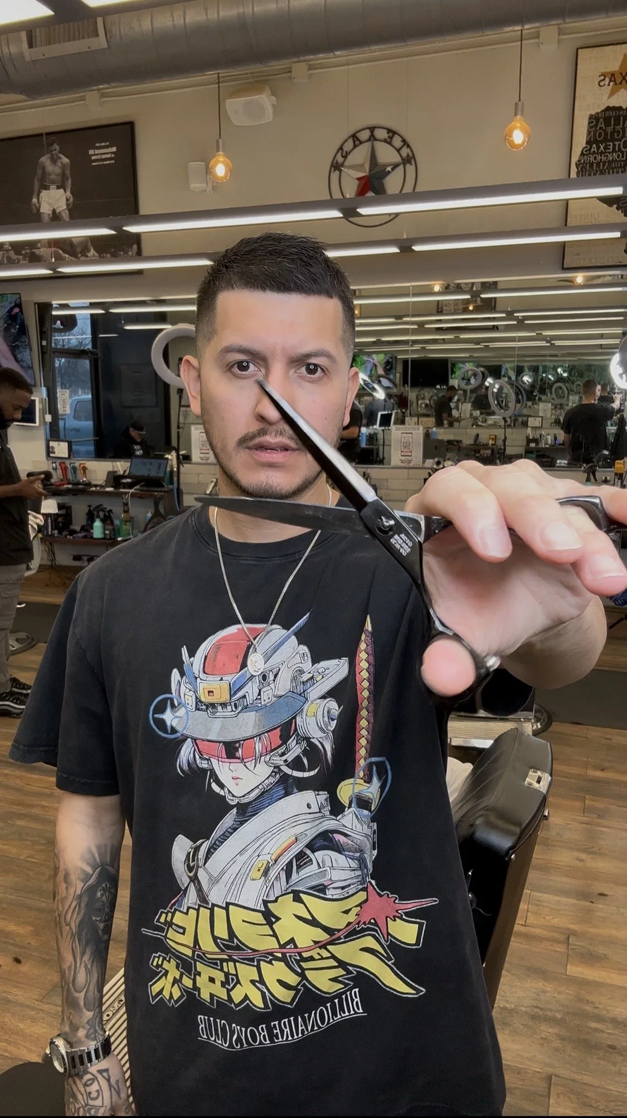 Barber Reiko Rodriquez performing precision detailing during a men’s haircut
