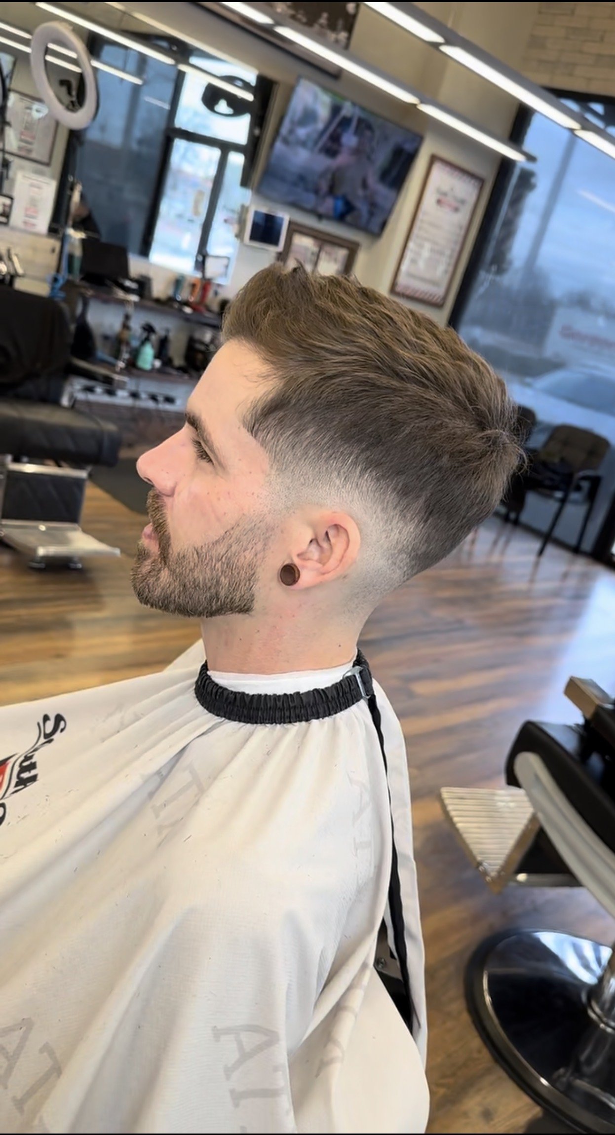 Finished men’s haircut showcasing clean fade and modern men’s style by Reiko Rodriquez