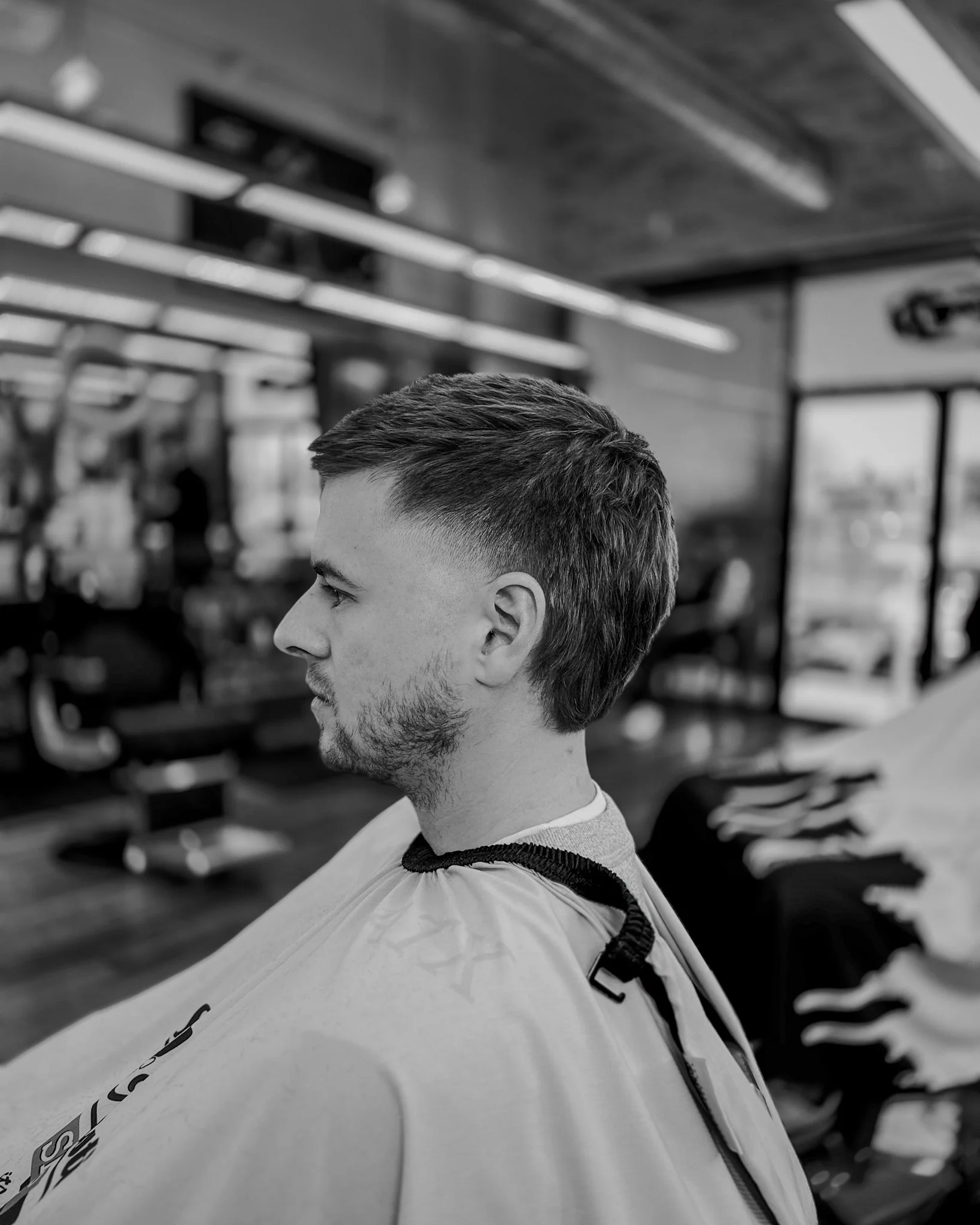 Men’s haircut in Austin by barber Reiko Rodriquez inside a barbershop