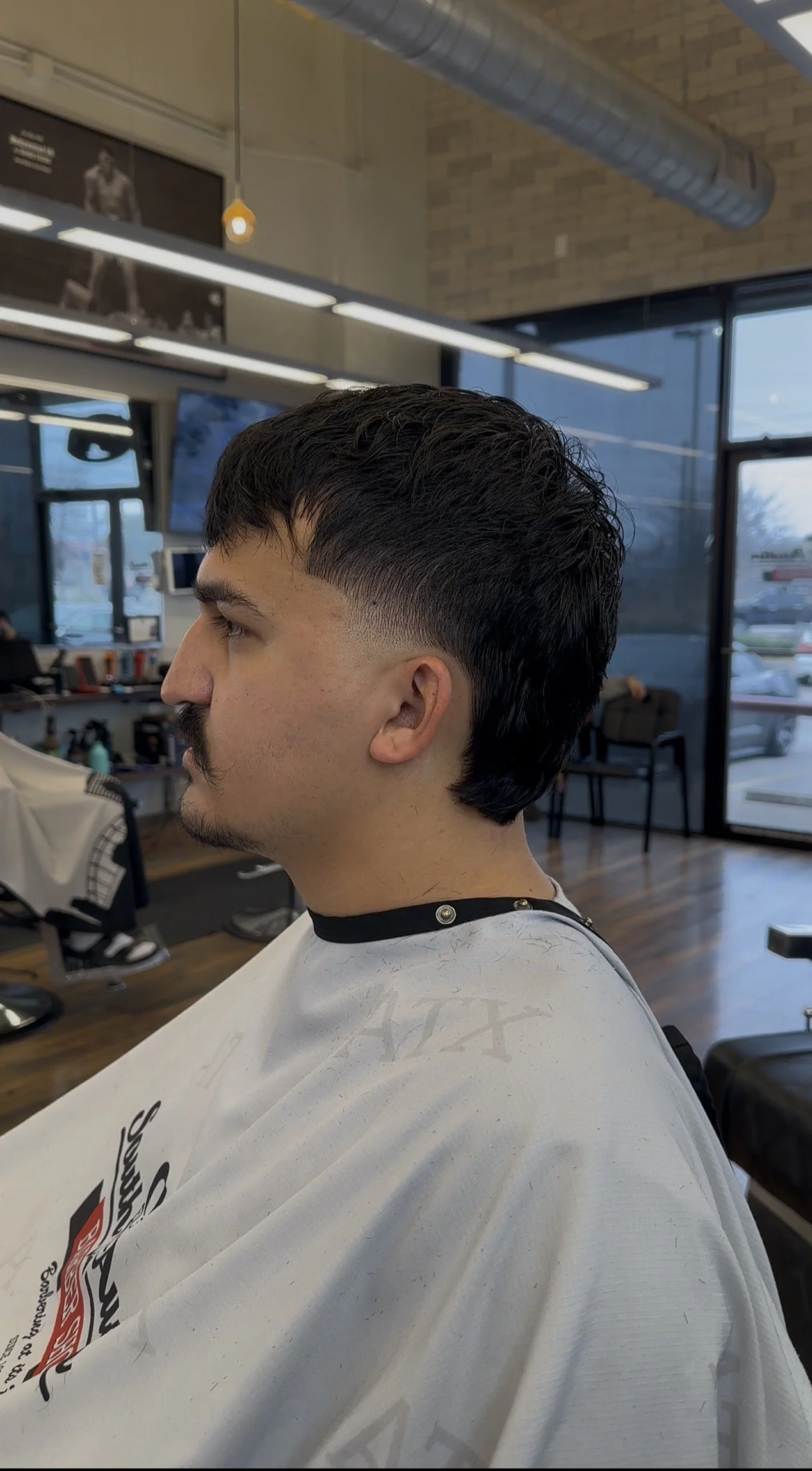 Men’s haircut in progress by professional barber Reiko Rodriquez in South Austin