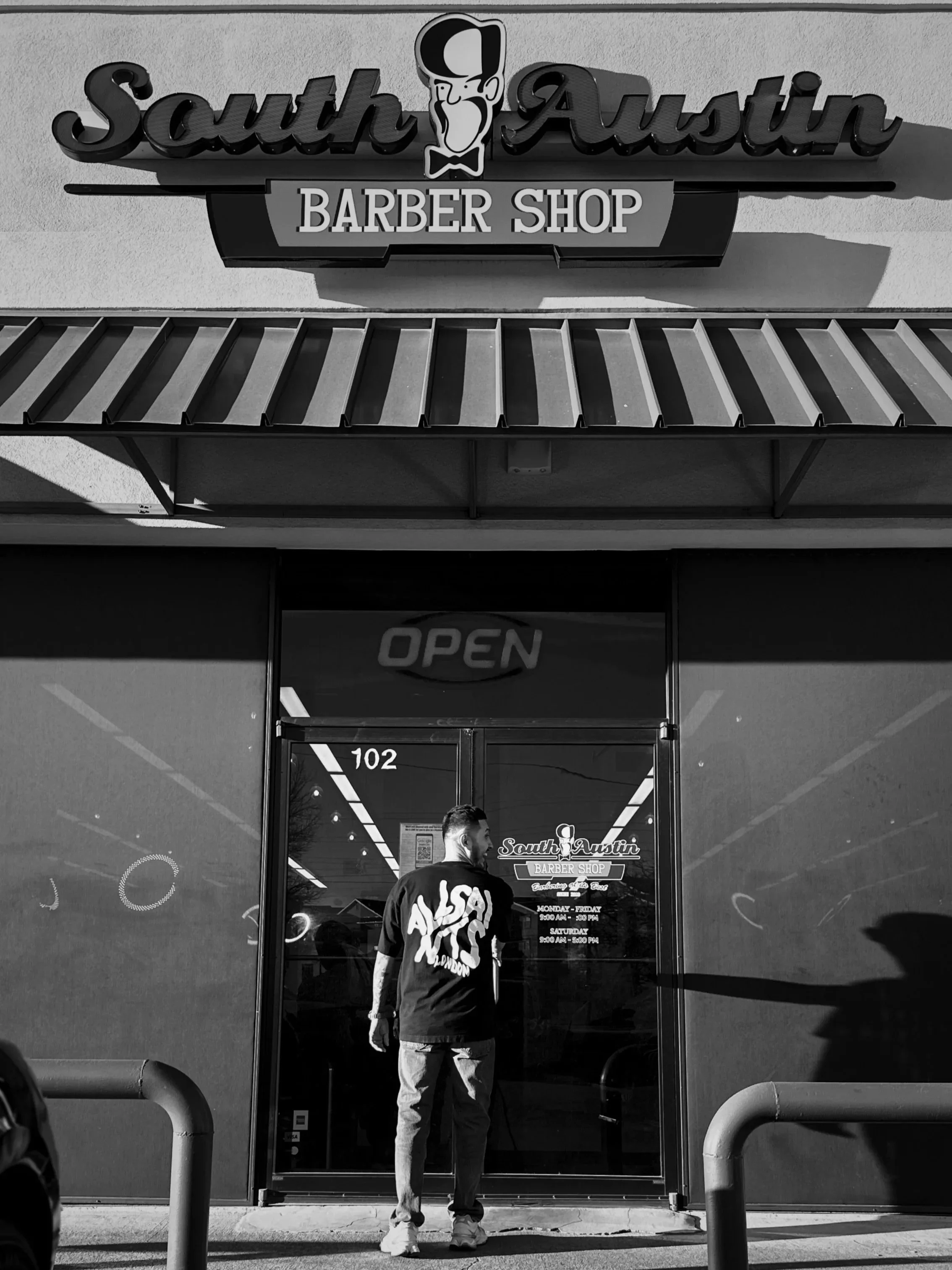 South Austin barber shop exterior with storefront entrance by Reiko Rodriquez