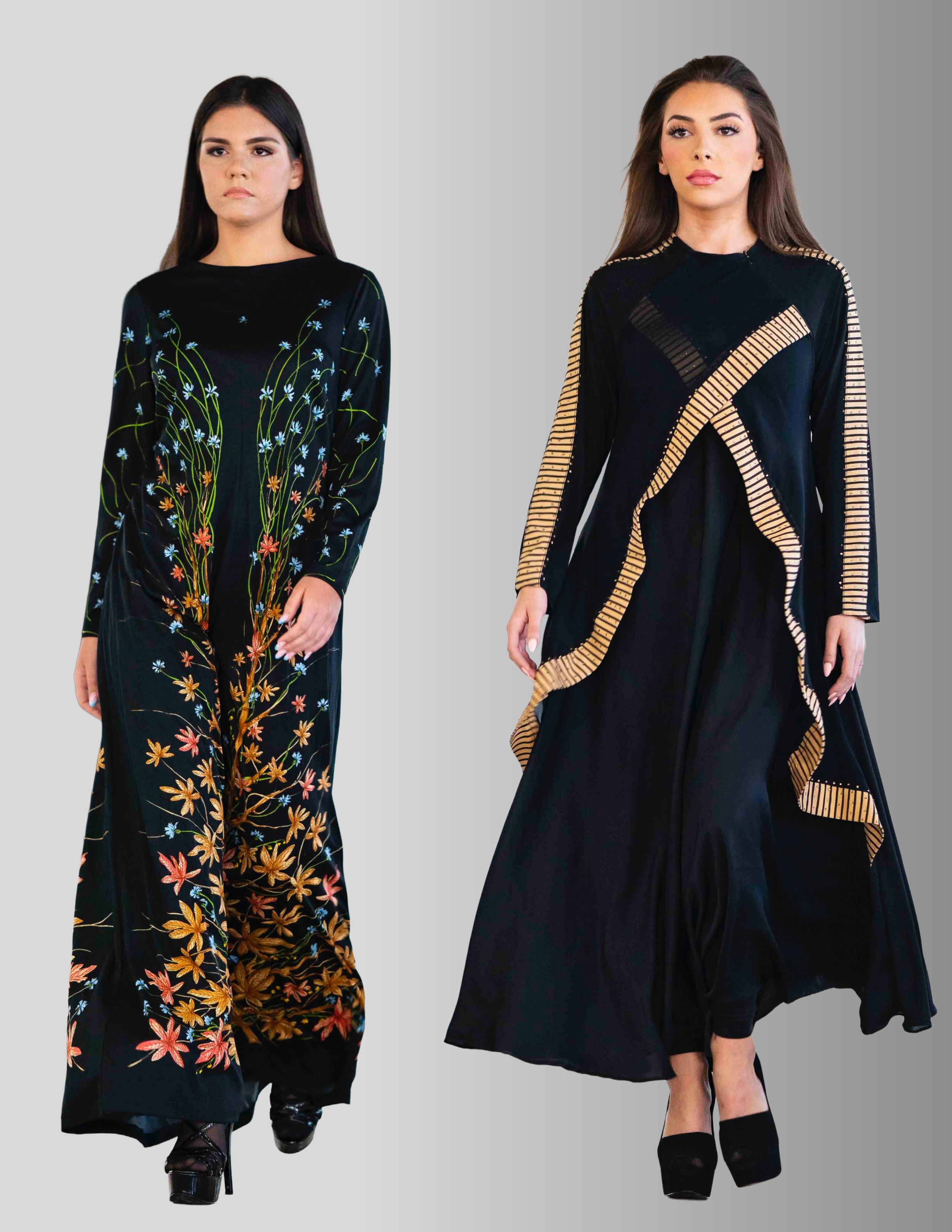 Two women wearing long black dresses with embroidered floral and geometric designs, walking on a gray background.