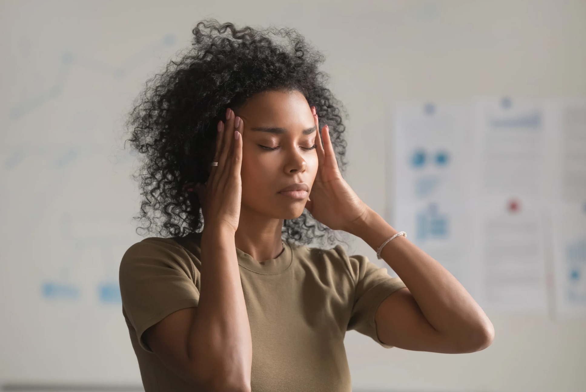 Close up of exhausted African American woman feel unwell touch massage templates, suffer from headache, tired black female worker have migraine or dizziness stand with eyes closed. Health problem concept