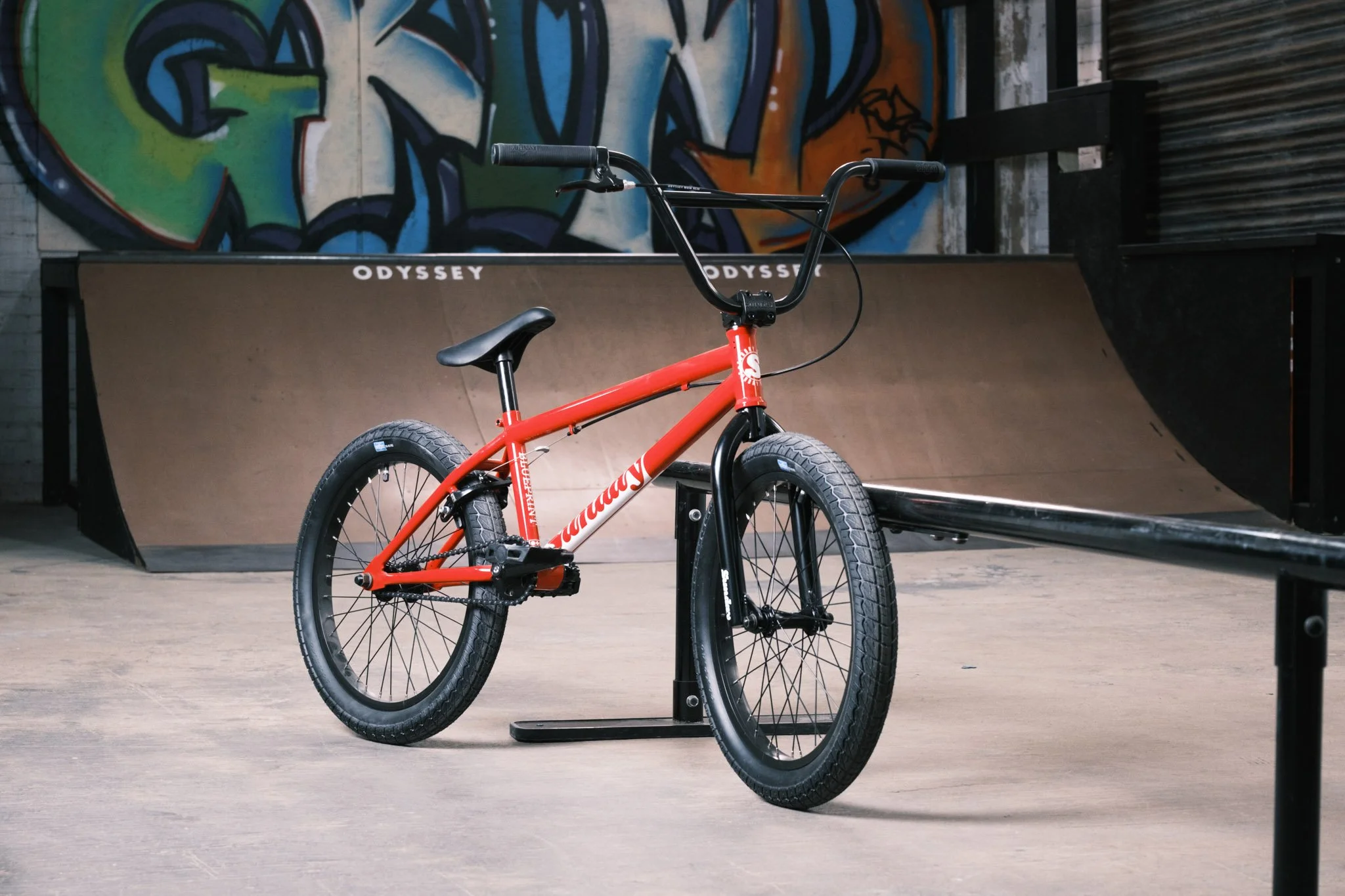 BMX bike in front of skate ramp