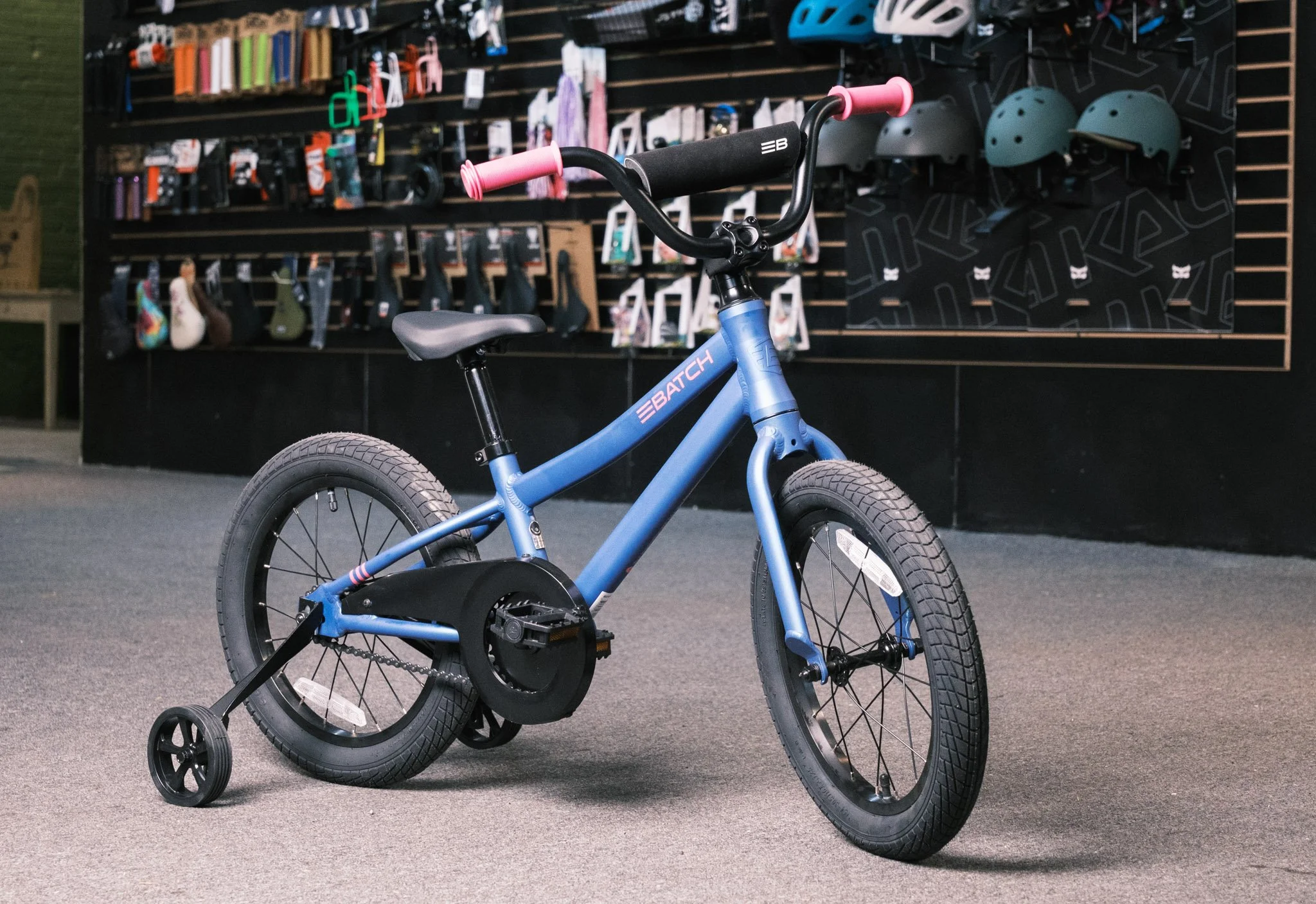 Children's bicycle with wall of bicycle accessories in the background