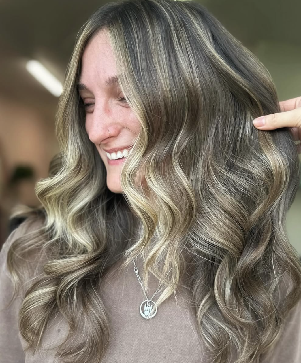 Woman with dark brown hair with blonde highlights