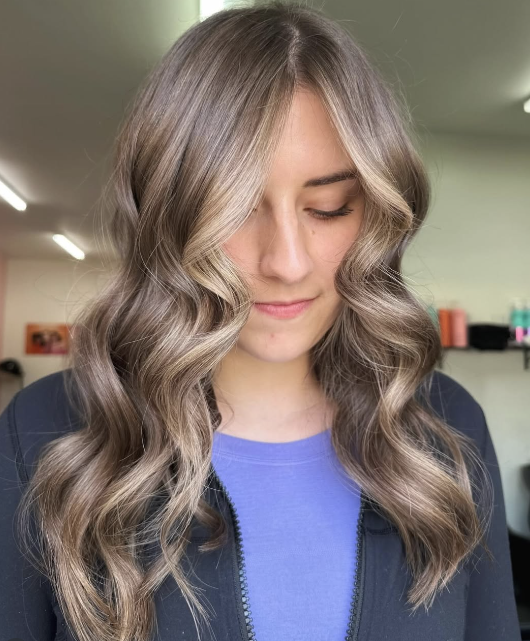 Woman with dark hair and "money piece" highlights