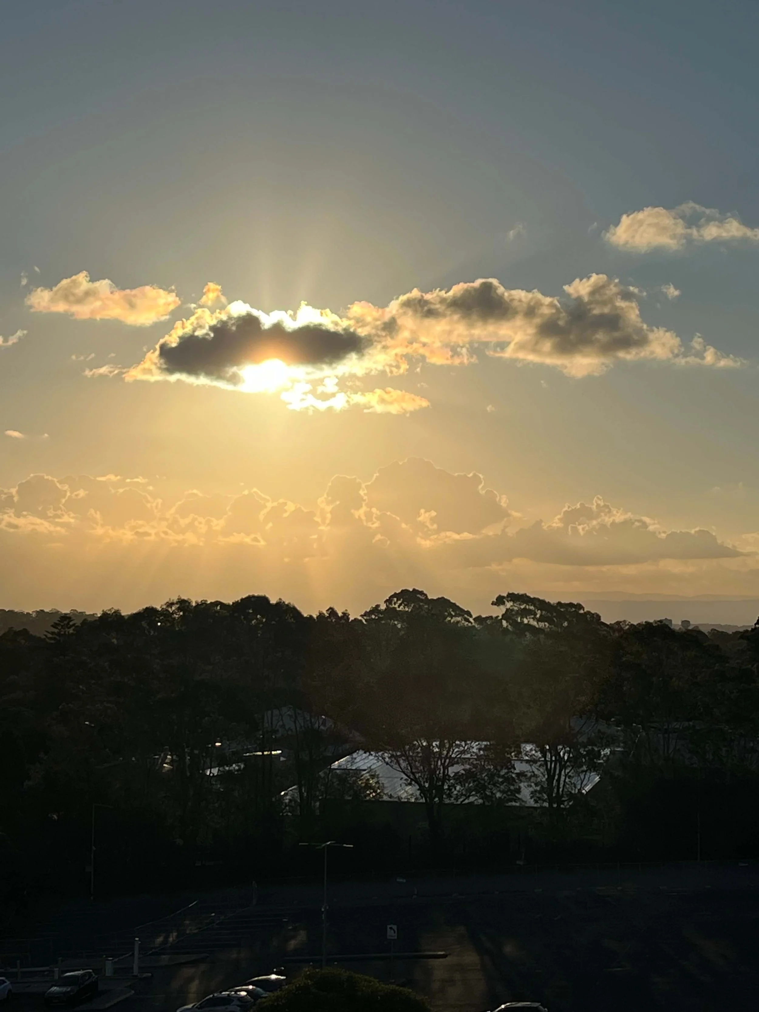 Rays of sunlight piercing through clouds, symbolising hope, clarity, and divine light
