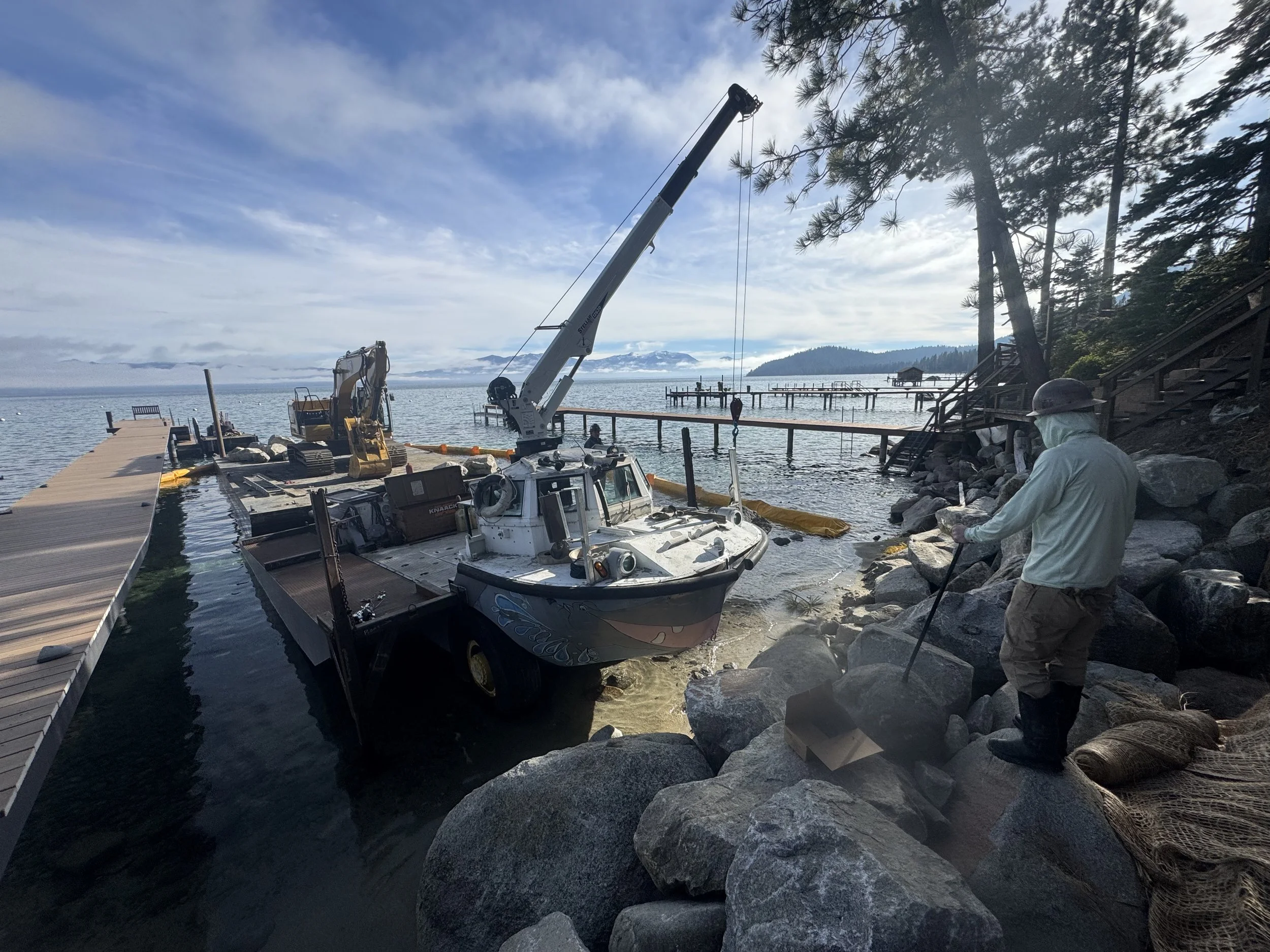 LARC 5 Amphibious Crane and Caterpillar 20 ton excavator with barge supporting a shoreline revetmwnt project on Lake Tahoe in the Meeks Bay and Rubicon Bay Area