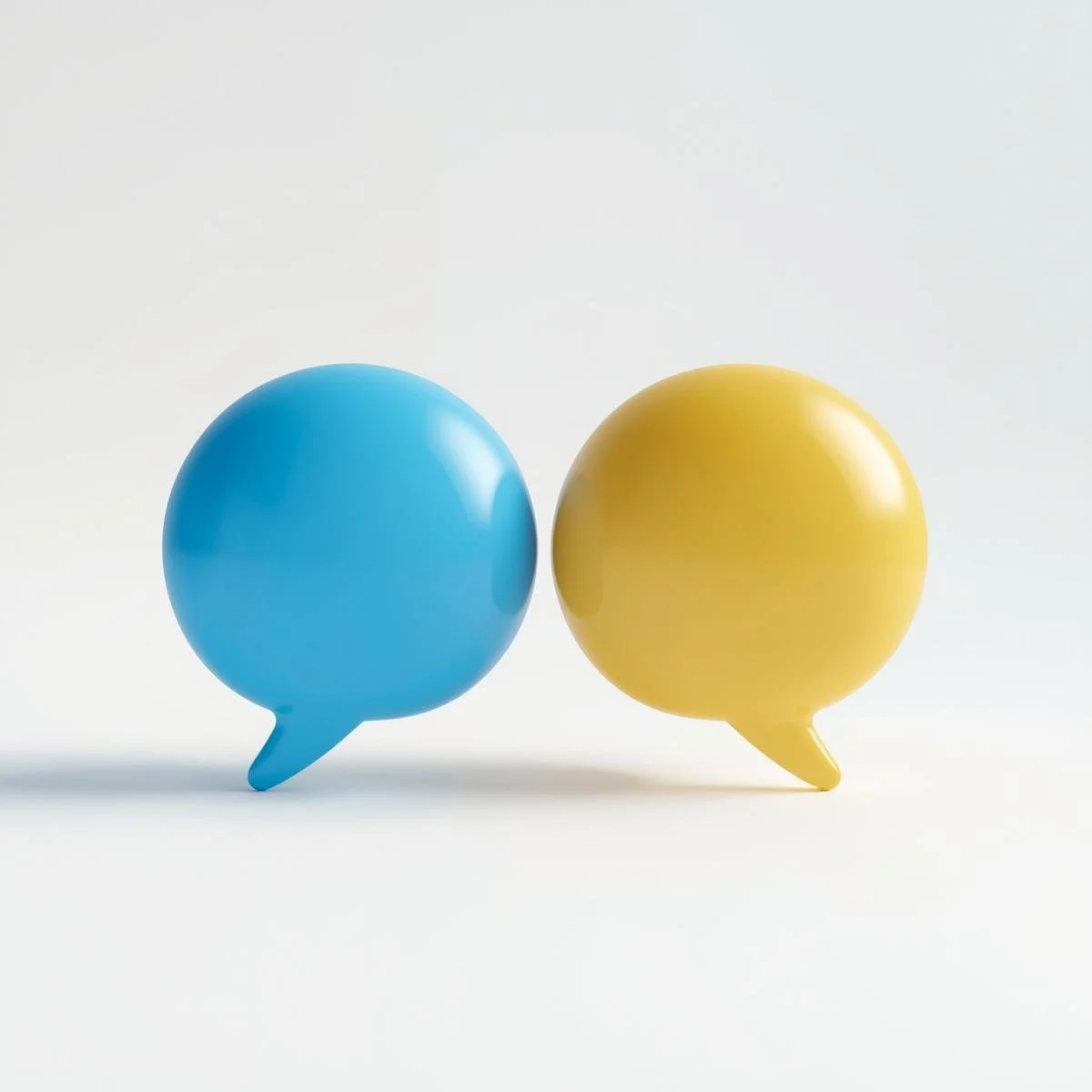 Blue and yellow speech bubble-shaped objects facing each other on a white background.