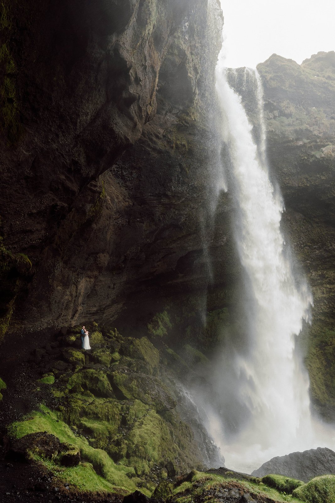 Elopement couple behind Seljalandsfoss waterfall in Iceland
