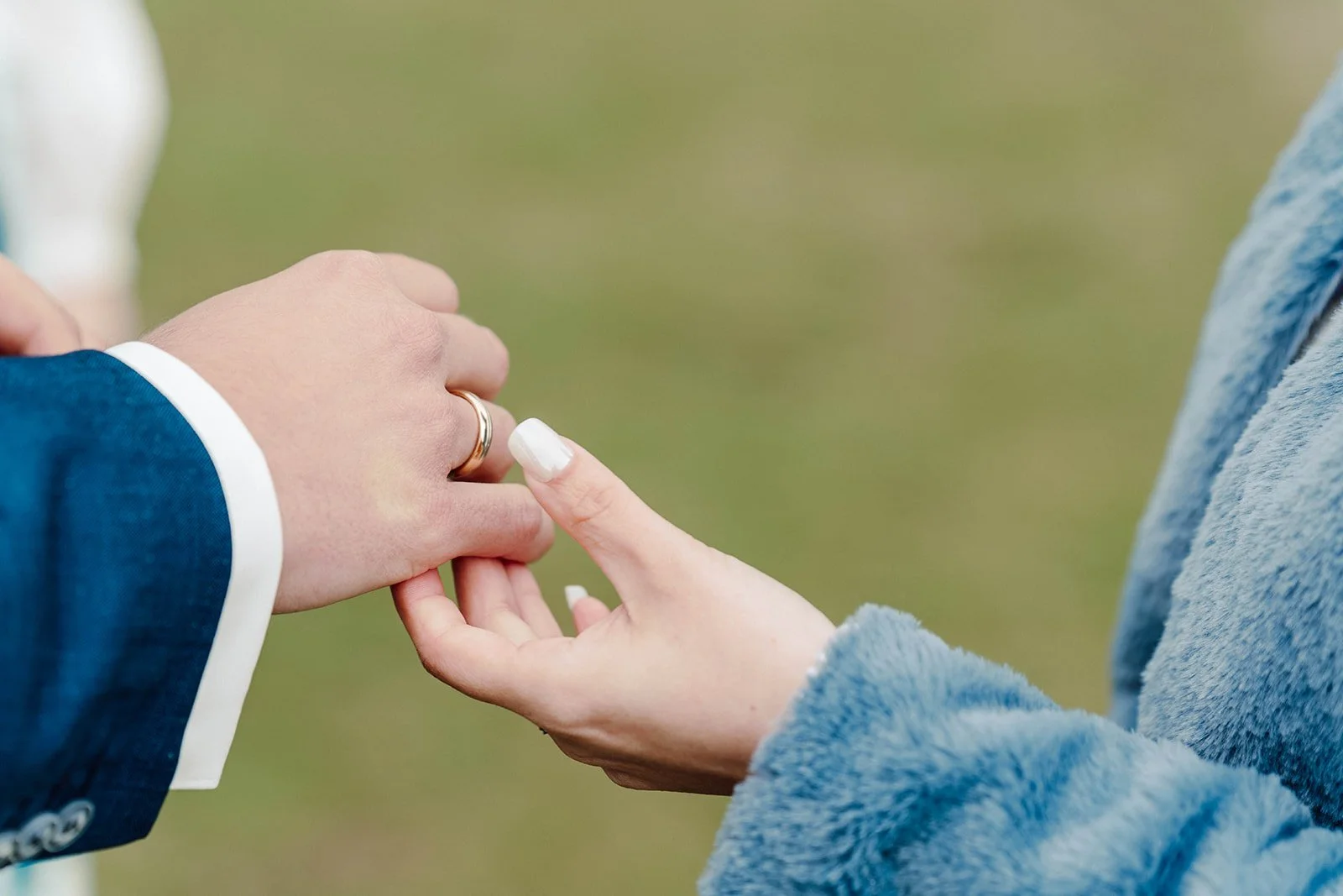 Bride placing wedding ring on groom's finger during an intimate elopement ceremony in Iceland