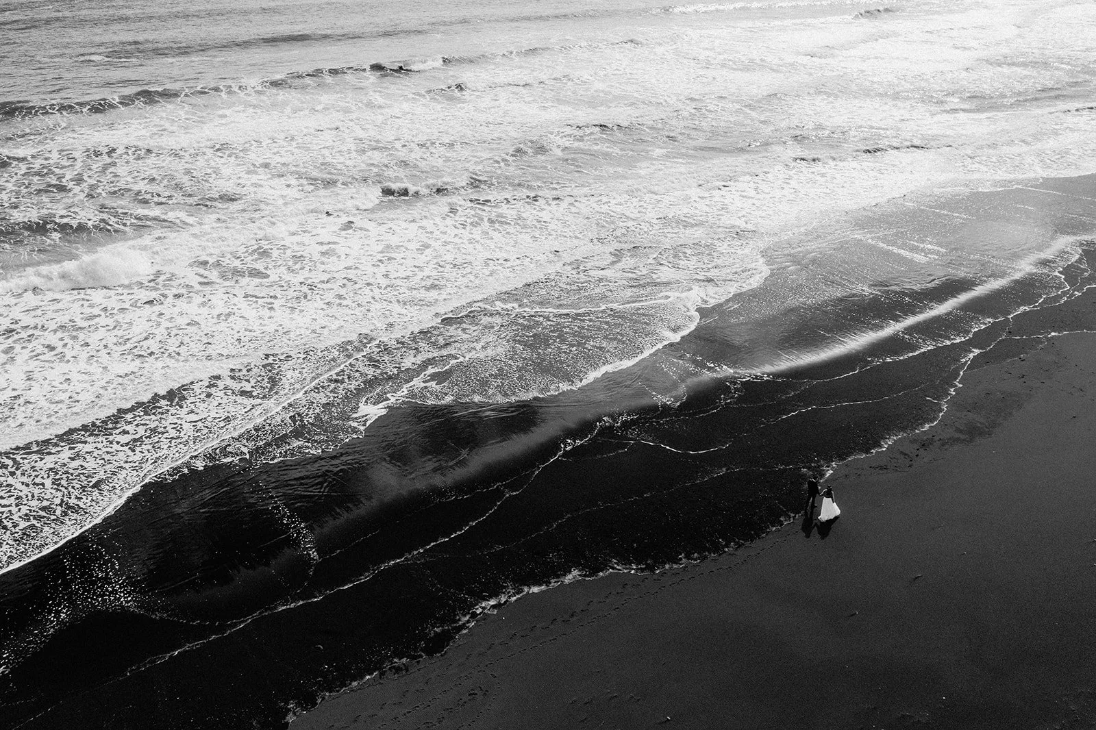 Black and white elopement photo on Iceland black sand beach
