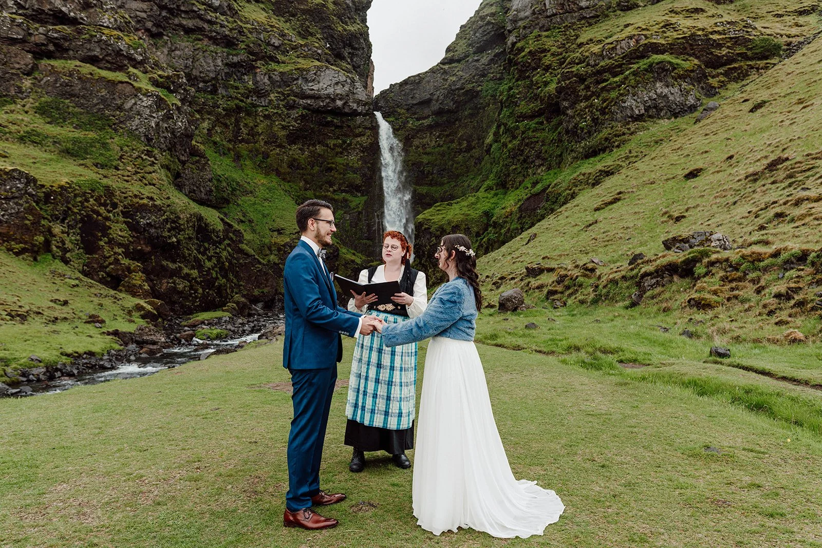 Bride and groom exchanging vows during an intimate waterfall elopement ceremony in Iceland