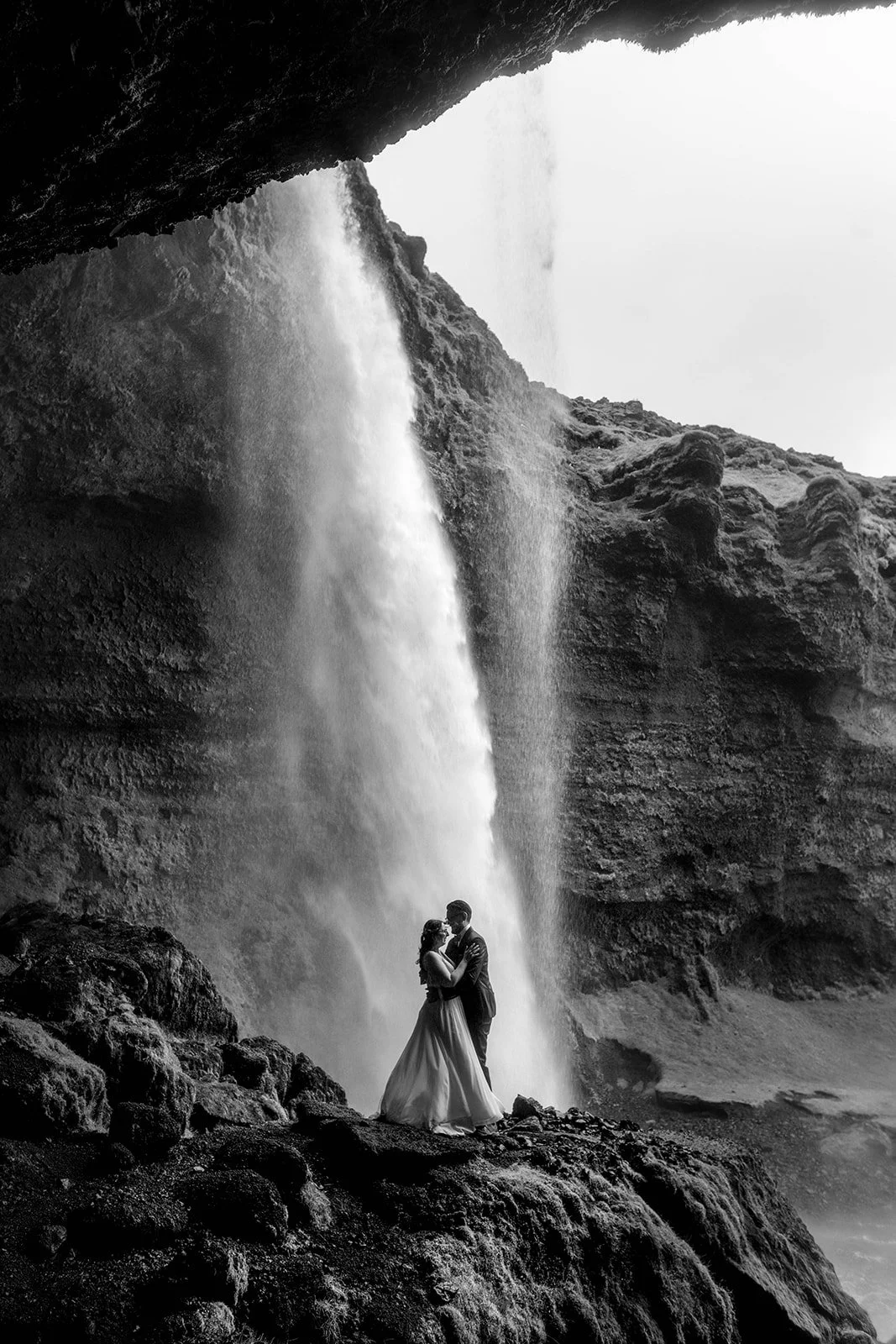 Black and white elopement behind Seljalandsfoss waterfall in Iceland
