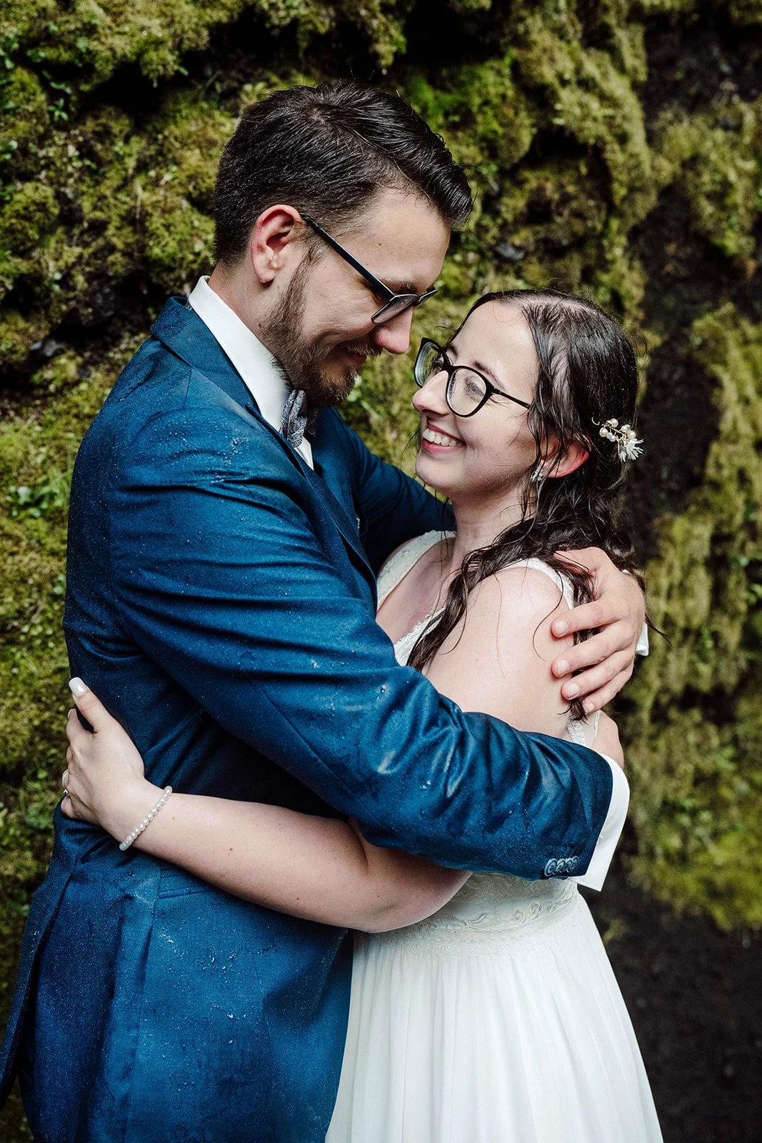 Emotional close-up of elopement couple in Iceland under waterfall