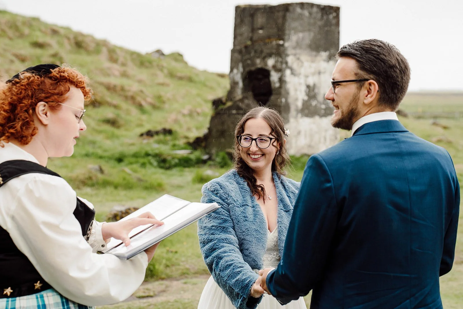 Bride and groom signing legal wedding documents during an outdoor elopement ceremony in Iceland
