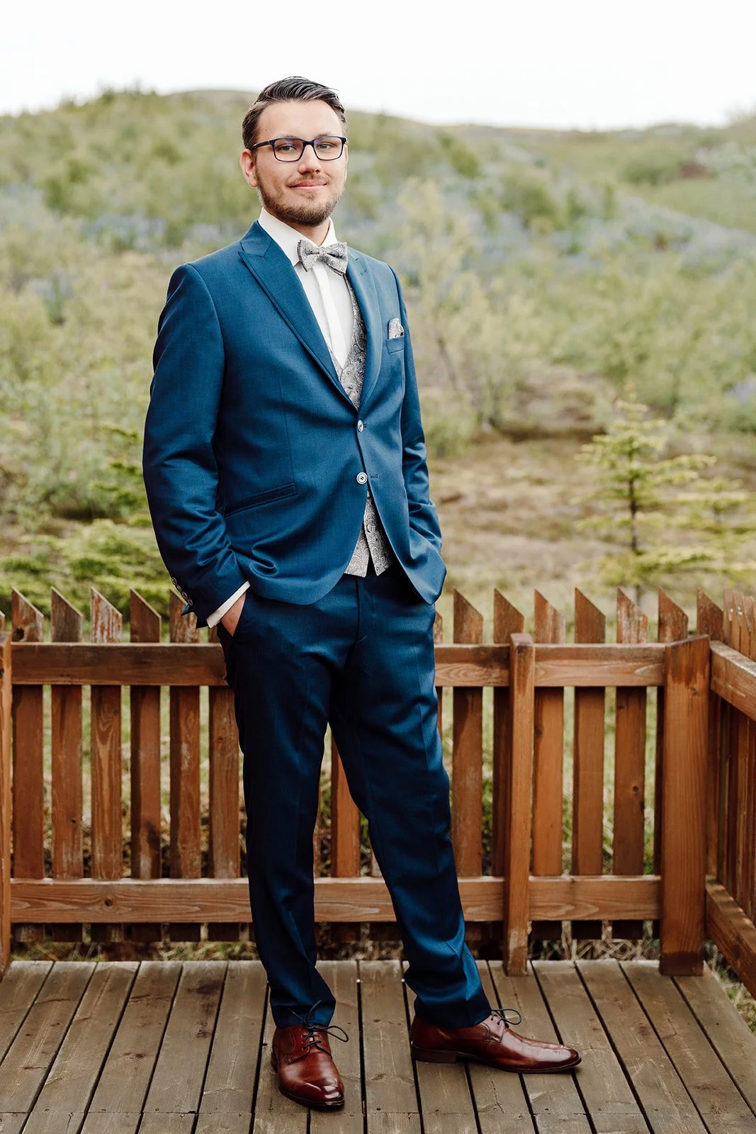 Portrait of a groom in a blue suit during an intimate elopement in Iceland surrounded by nature