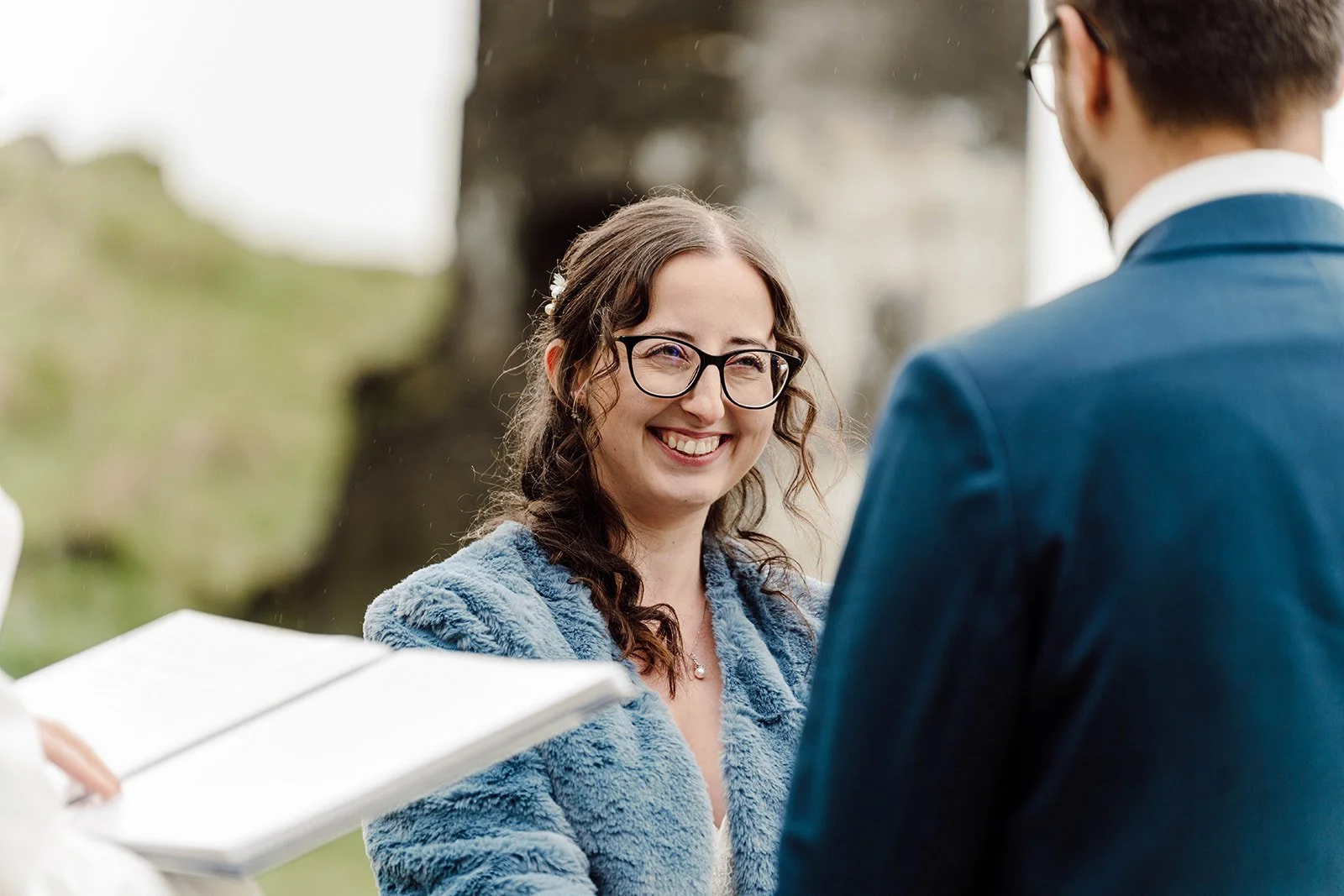 Smiling bride reacting emotionally during her wedding vows at an Iceland elopement ceremony