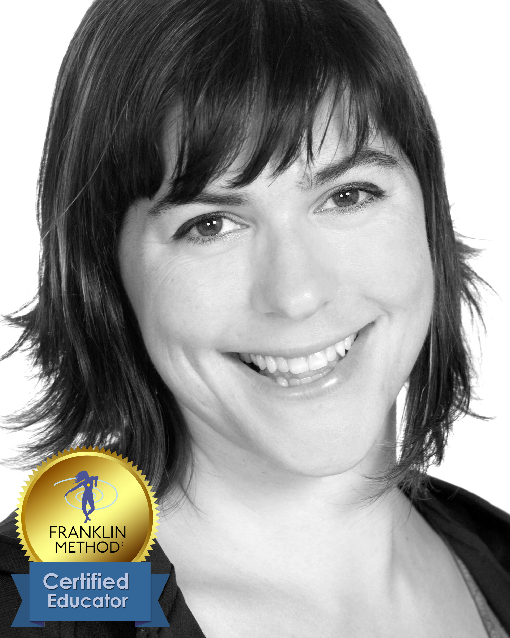 Black and white close-up portrait of a smiling woman with short dark hair, wearing a dark top, featuring an award badge in the bottom left corner that says "Franklin Method Certified Educator."