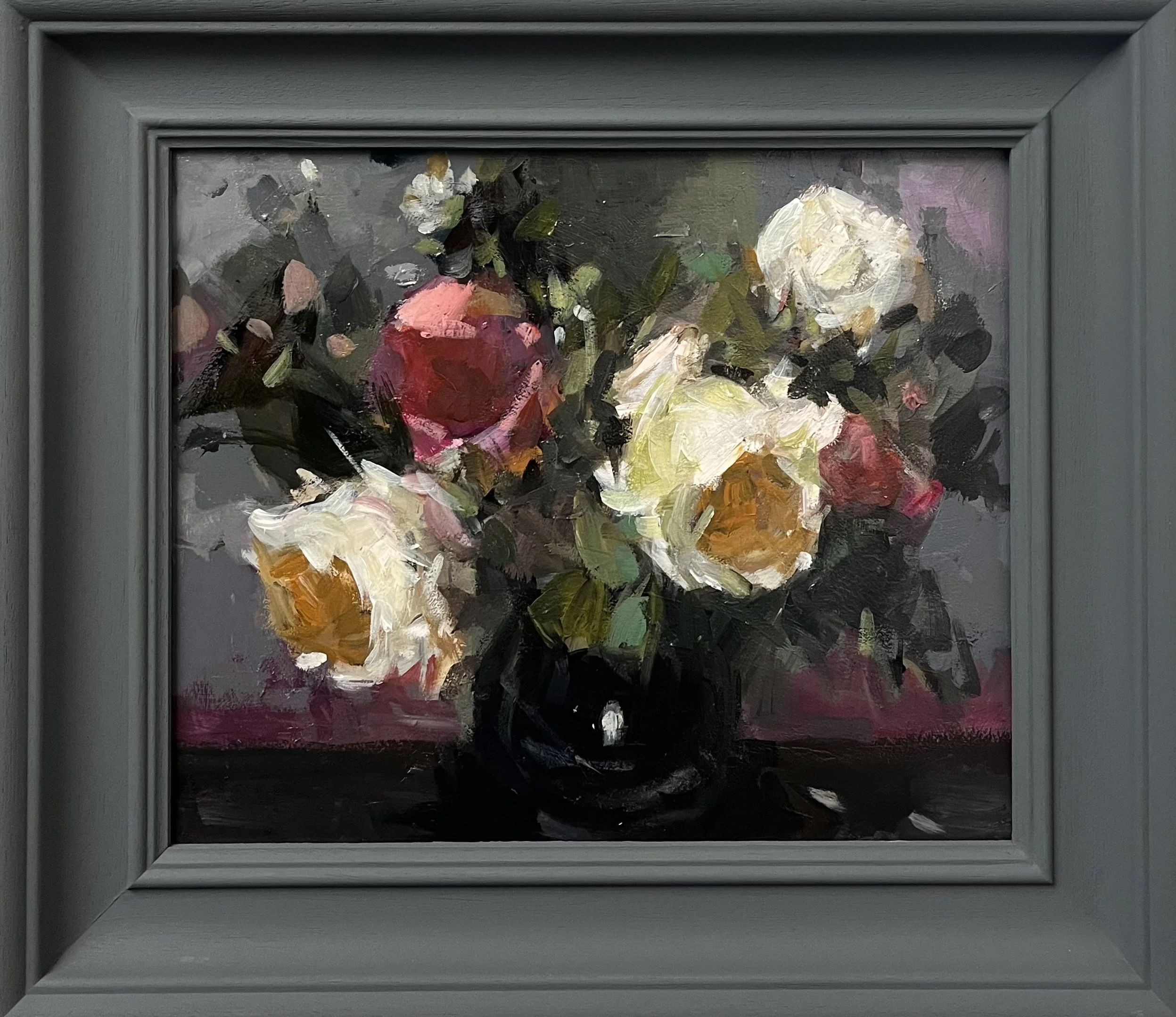 White roses in a black vase