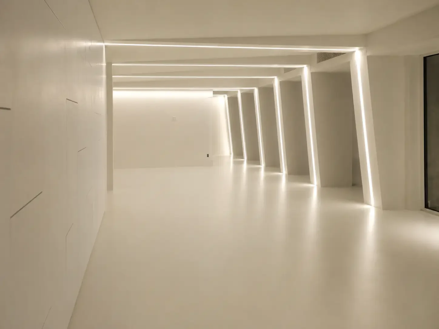 Minimal villa corridor in China with seamless microcement floor and linear lighting.